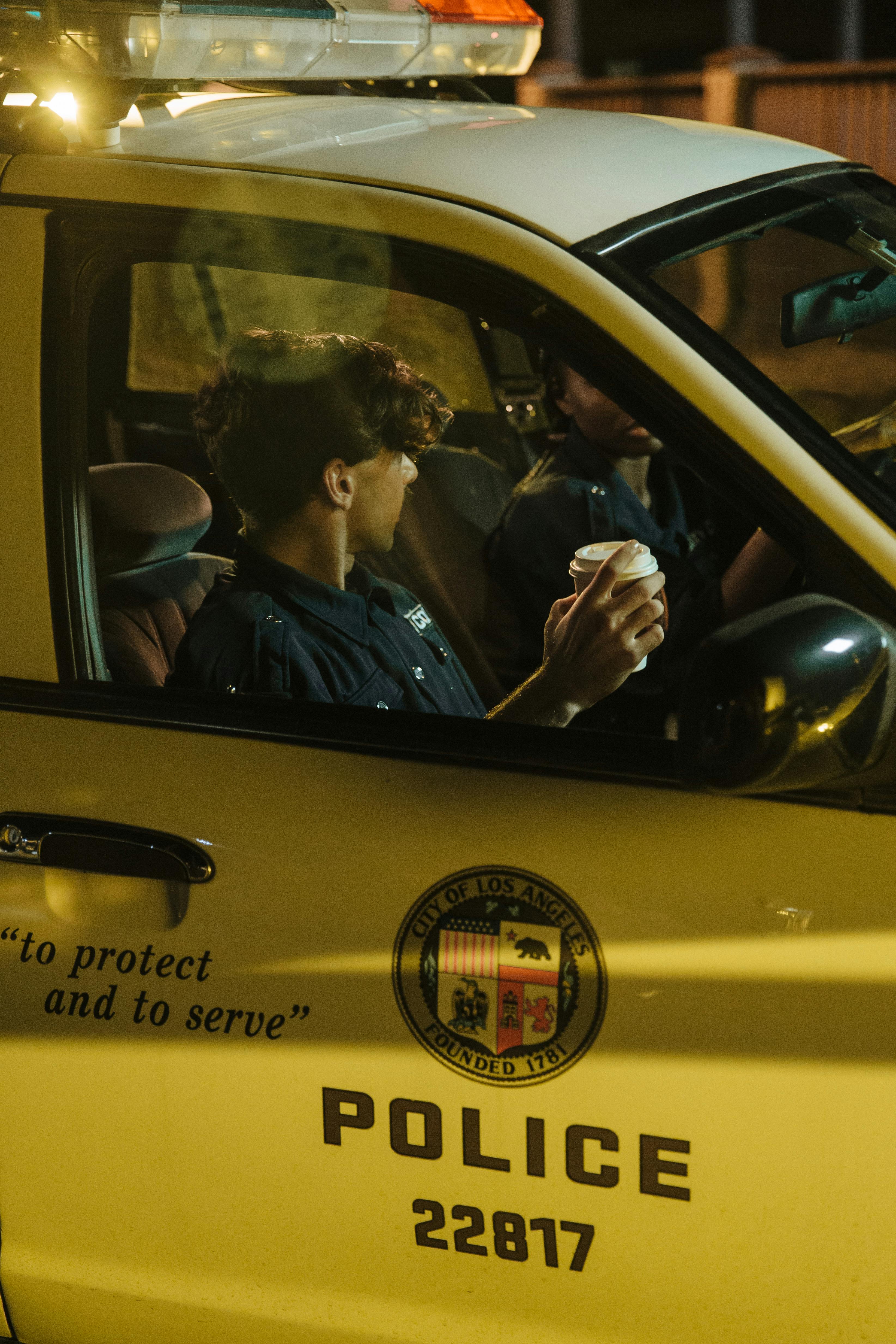 Two officers inside a police vehicle | Source: Pexels