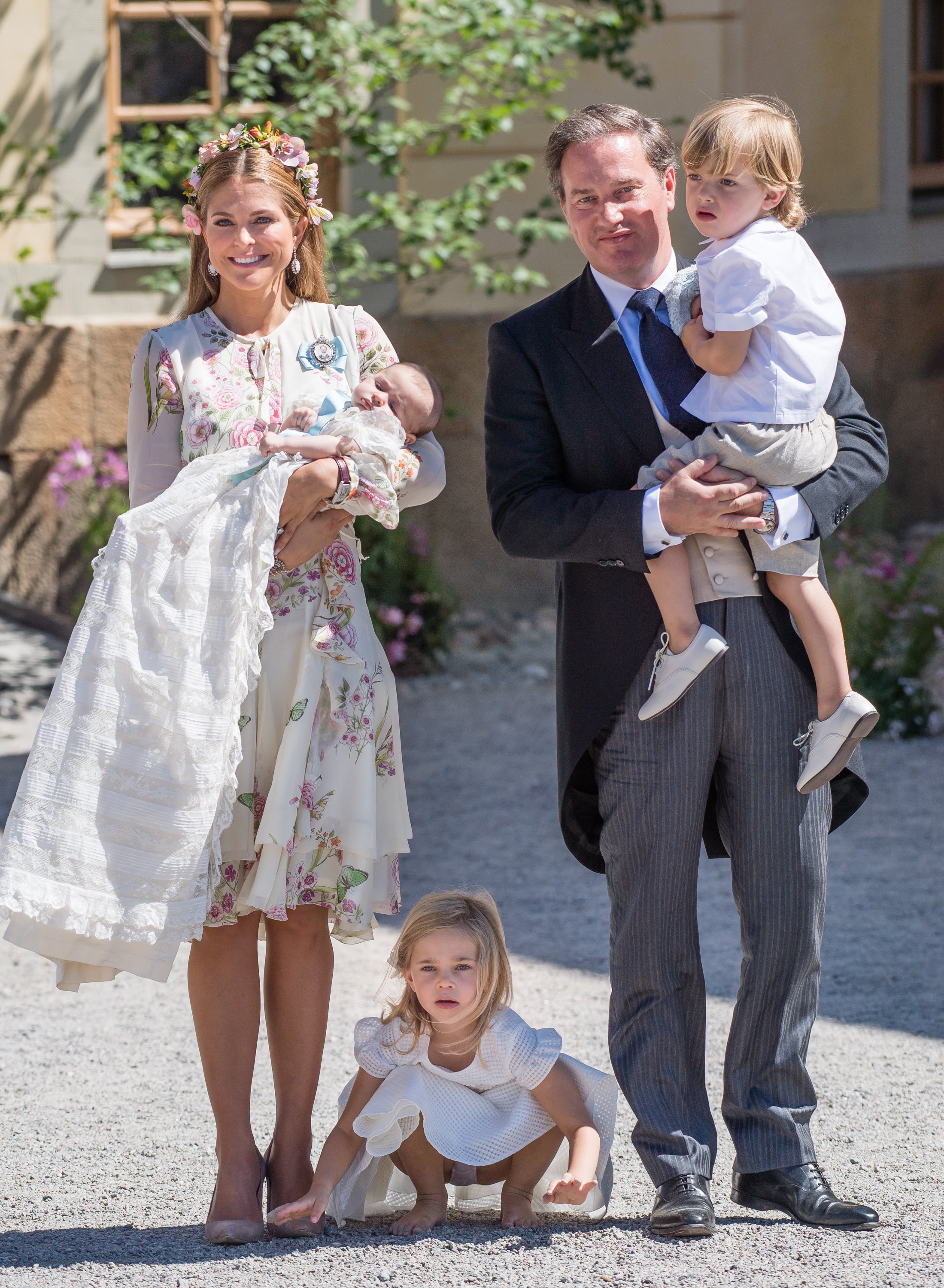 Princess Madeleine of Sweden holding Princess Adrienne while her husband Christopher O'Neill holds Prince Nicolas. Their eldest, Princess Leonore squats in the middle on June 8, 2018 | Source: Getty Images