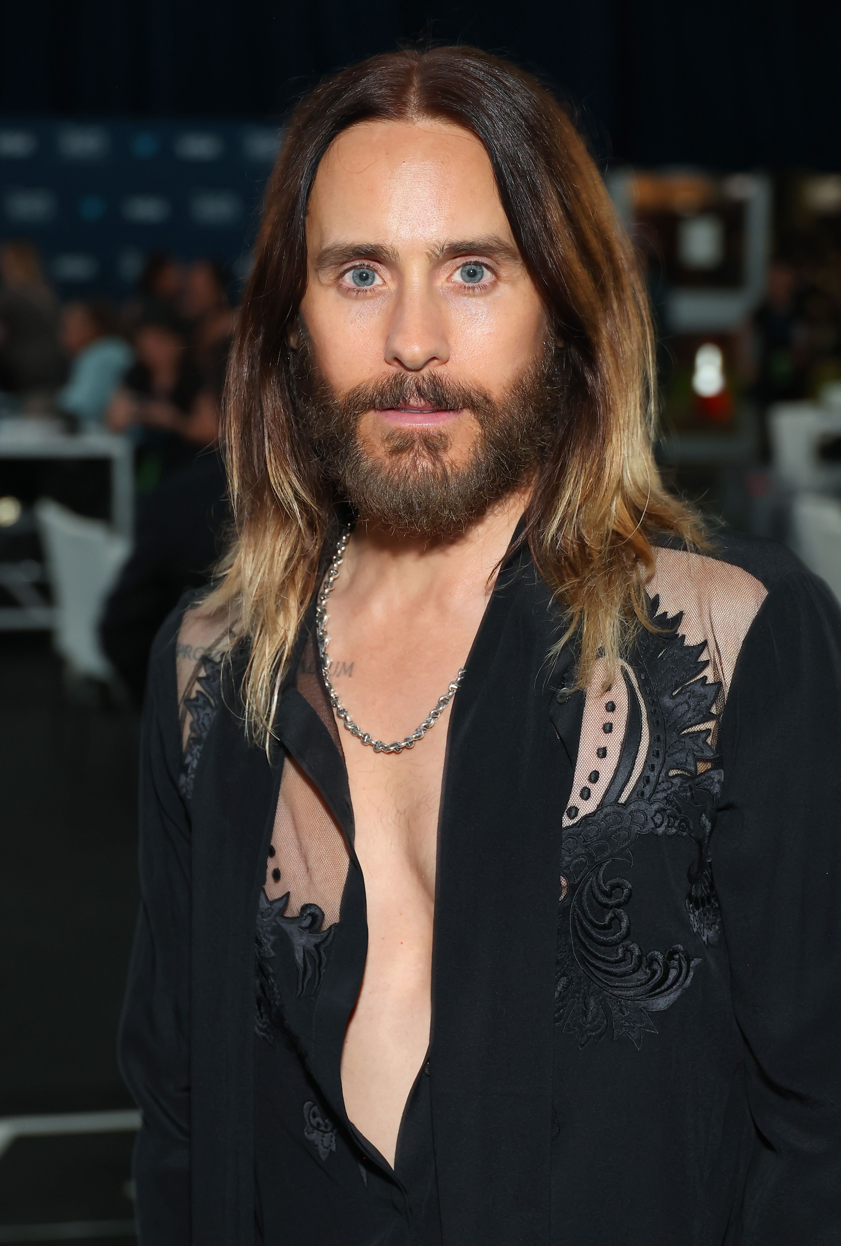 Leto, now 53, arrived at the Hollywood premiere of "Tron: Ares" looking like he stepped out of a futuristic dream. With glowing skin, tousled chestnut hair, and a flowing white shirt unbuttoned to the sternum, he blended rock star mystique with sci-fi cool. His ageless face and intense stare gave him an almost surreal presence — more otherworldly than earthbound.