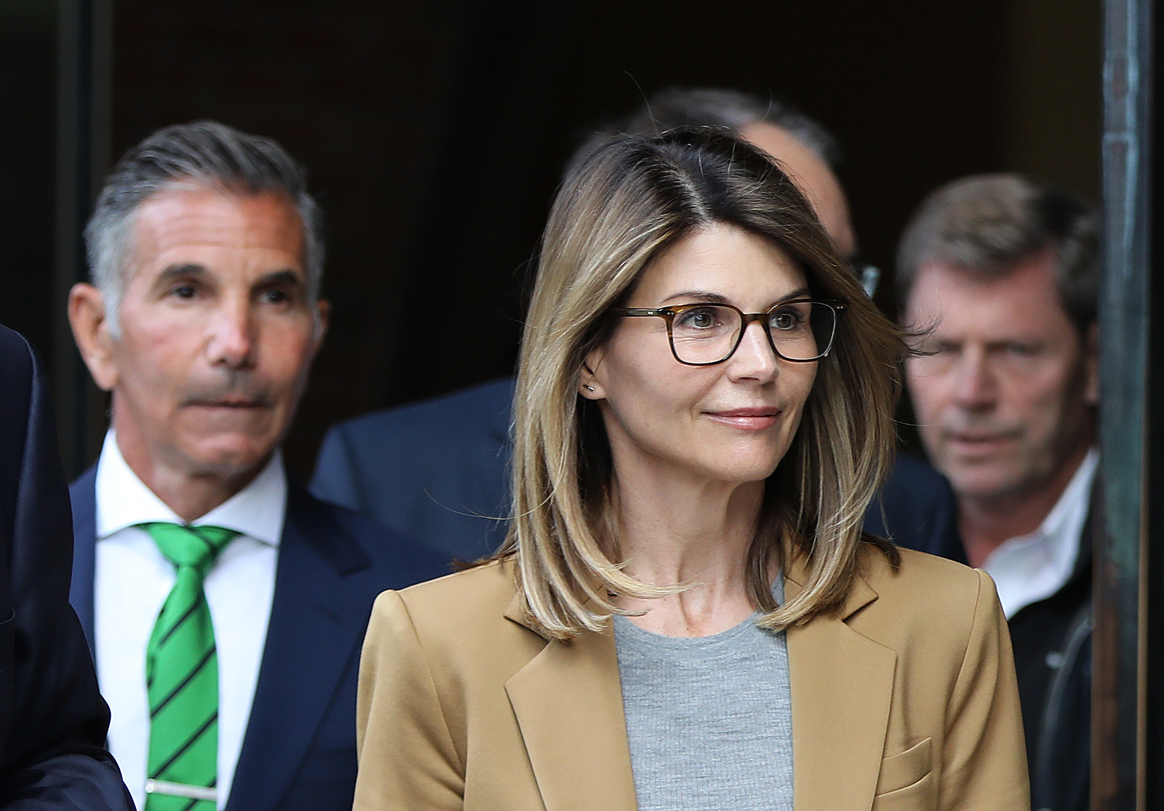 Lori Loughlin and her husband Mossimo Giannulli, on the left, leaving the courthouse on April 3, 2019 | Source: Getty Images