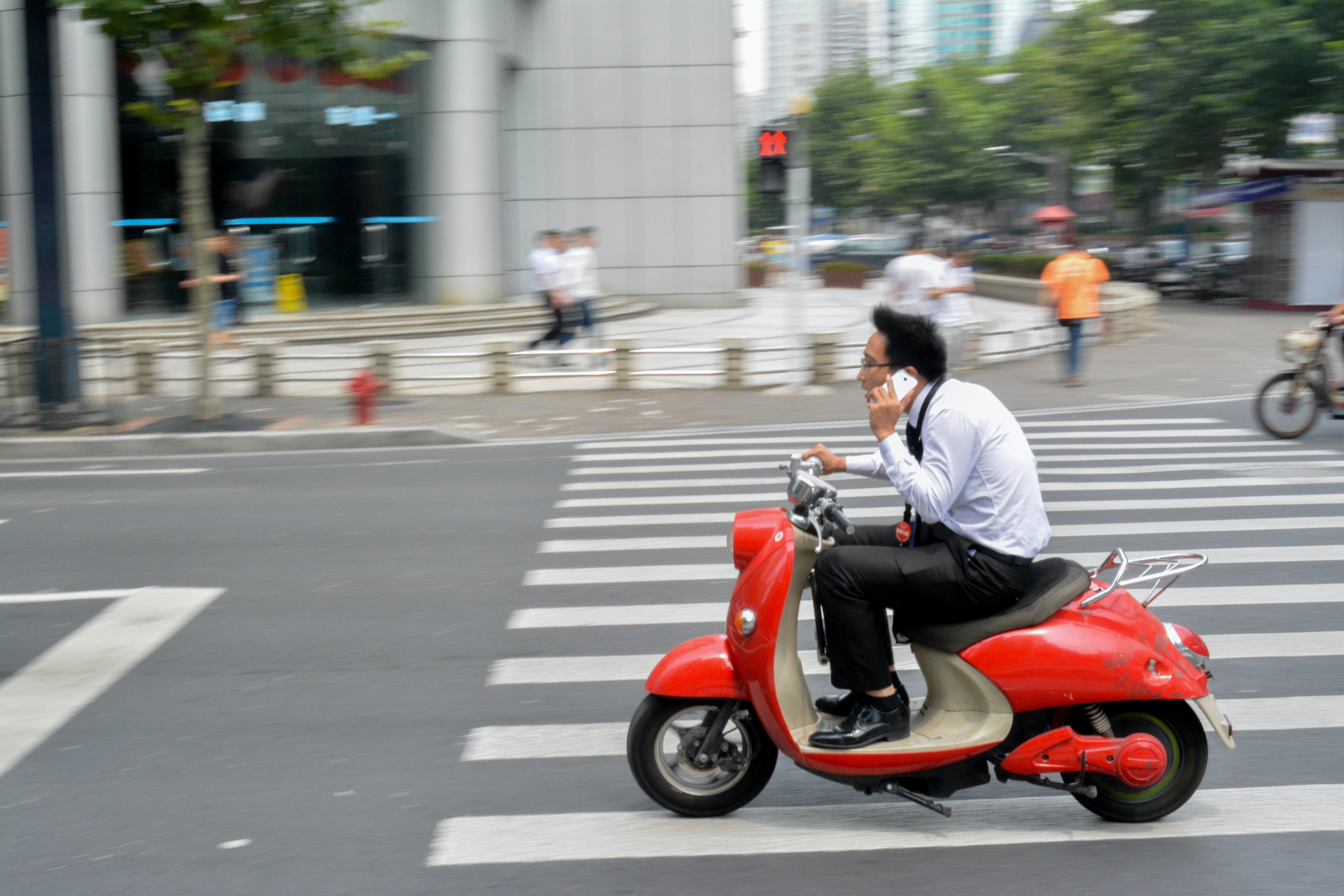 Man riding a moped. | Photo: Pexels