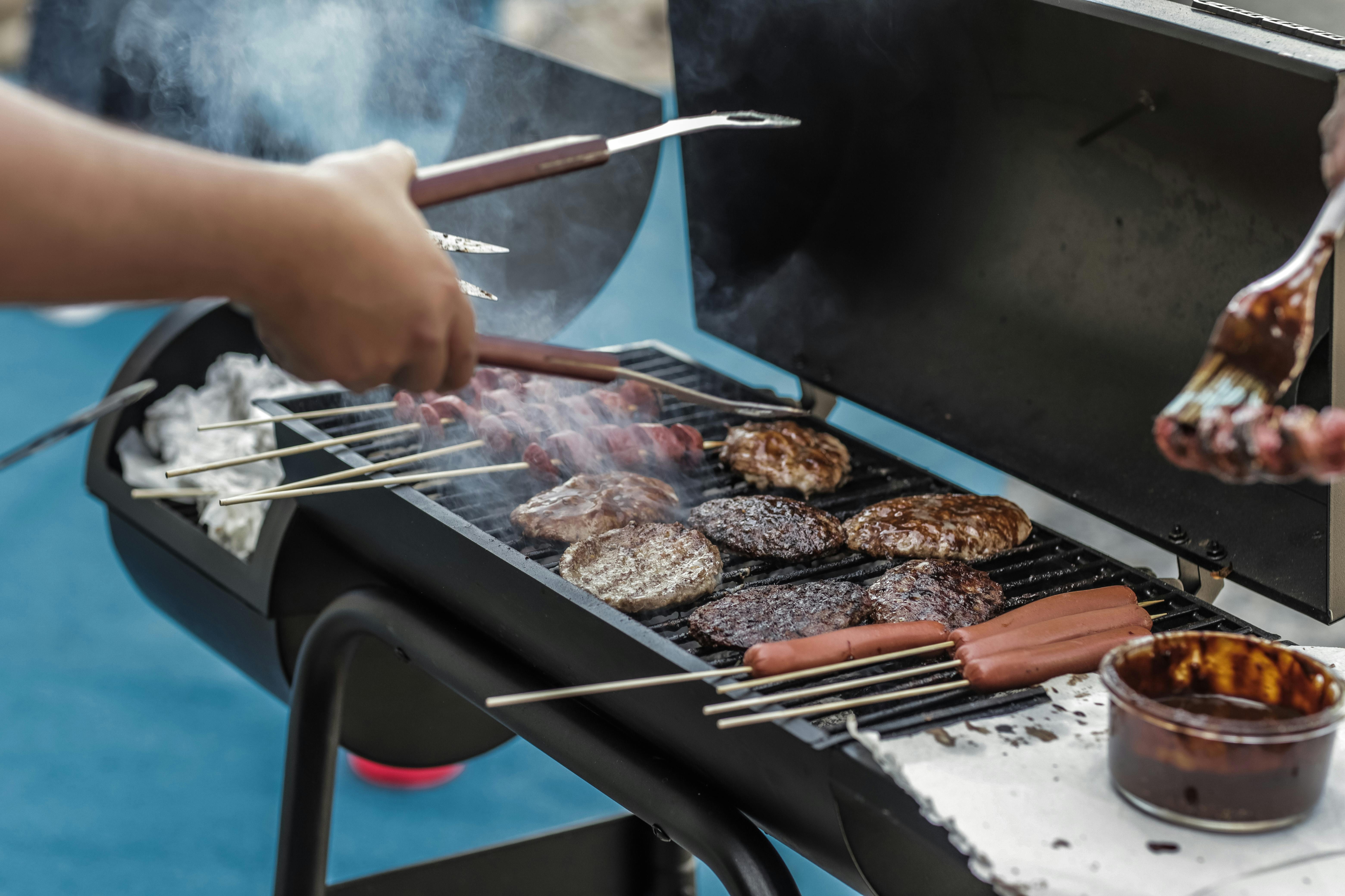 A man grills sausages and meat | Source: Pexels