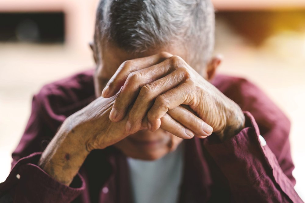 An embarrassed senior man covering his face with his hands. | Photo: Shutterstock