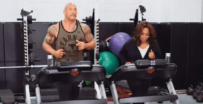 Dwayne Johnson and Oprah running the treadmill in their new 2020 Weight Watchers commercial. | Source: YouTube/WW formerly Weight Watchers.