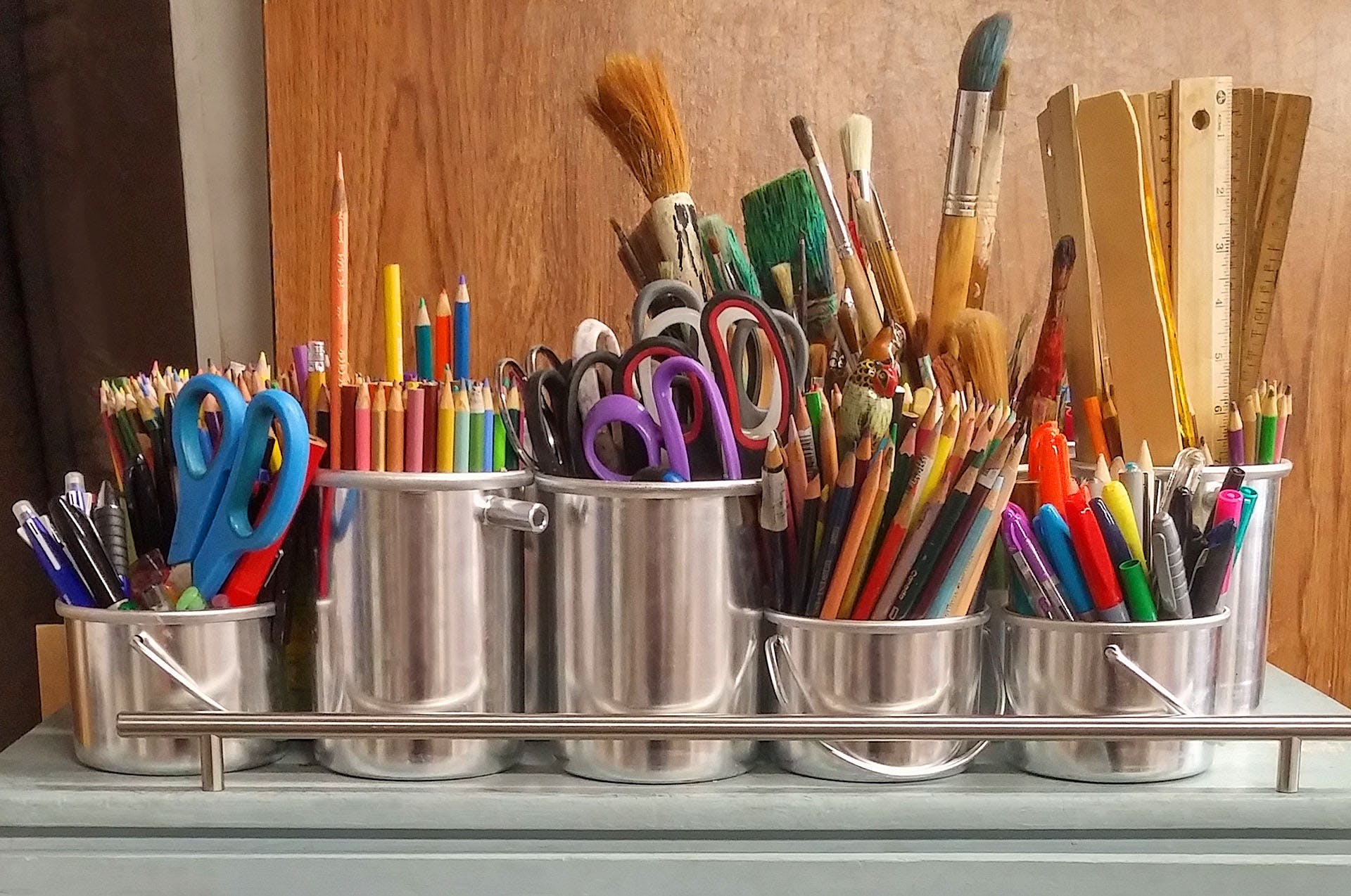 Art supplies in steel buckets | Source: Pexels