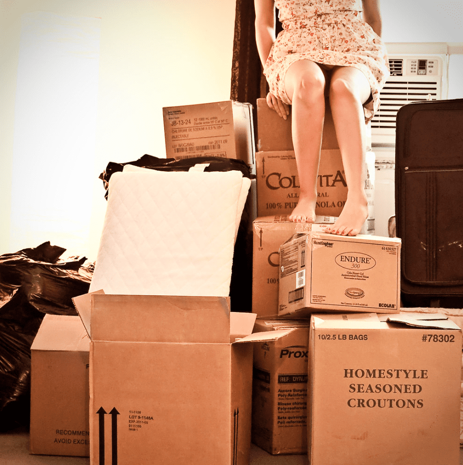 A woman sorting things into boxes. | Source: flickr.com