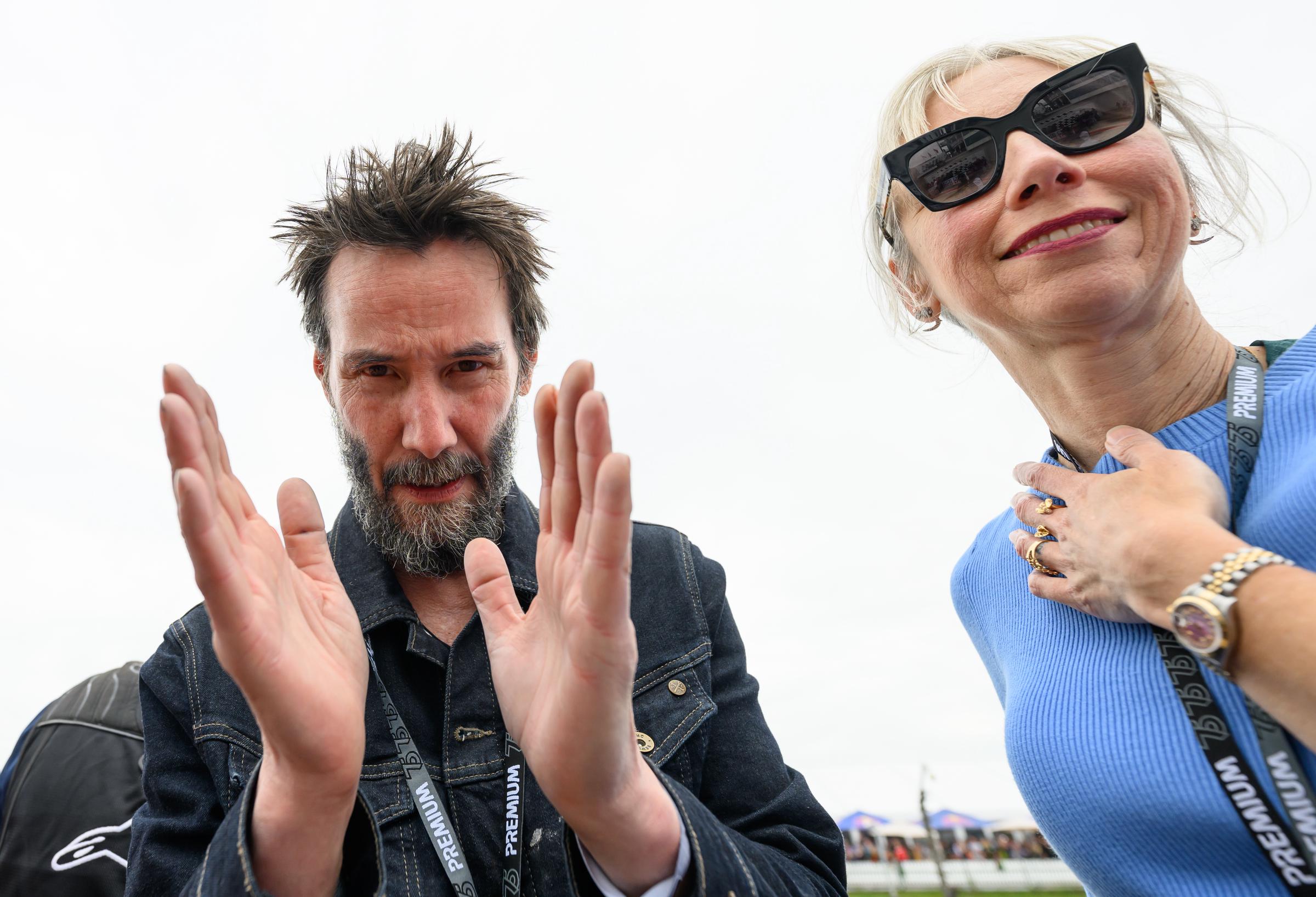 Keanu Reeves and Alexandra Grant stand in the MotoGP German Grand Prix pit lane on July 7, 2024. | Source: Getty Images