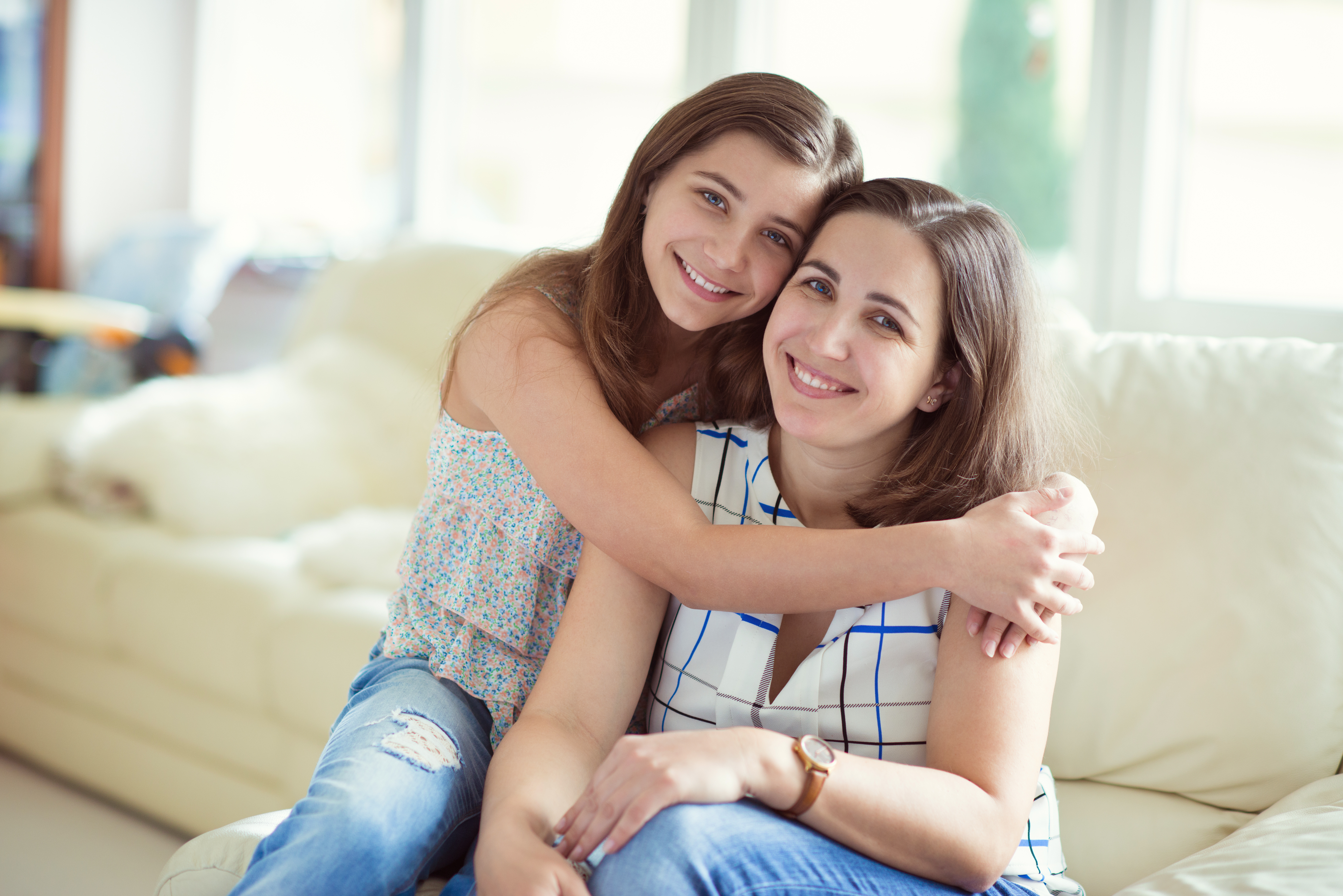 A teen girl hugs her mother | Source: Shutterstock