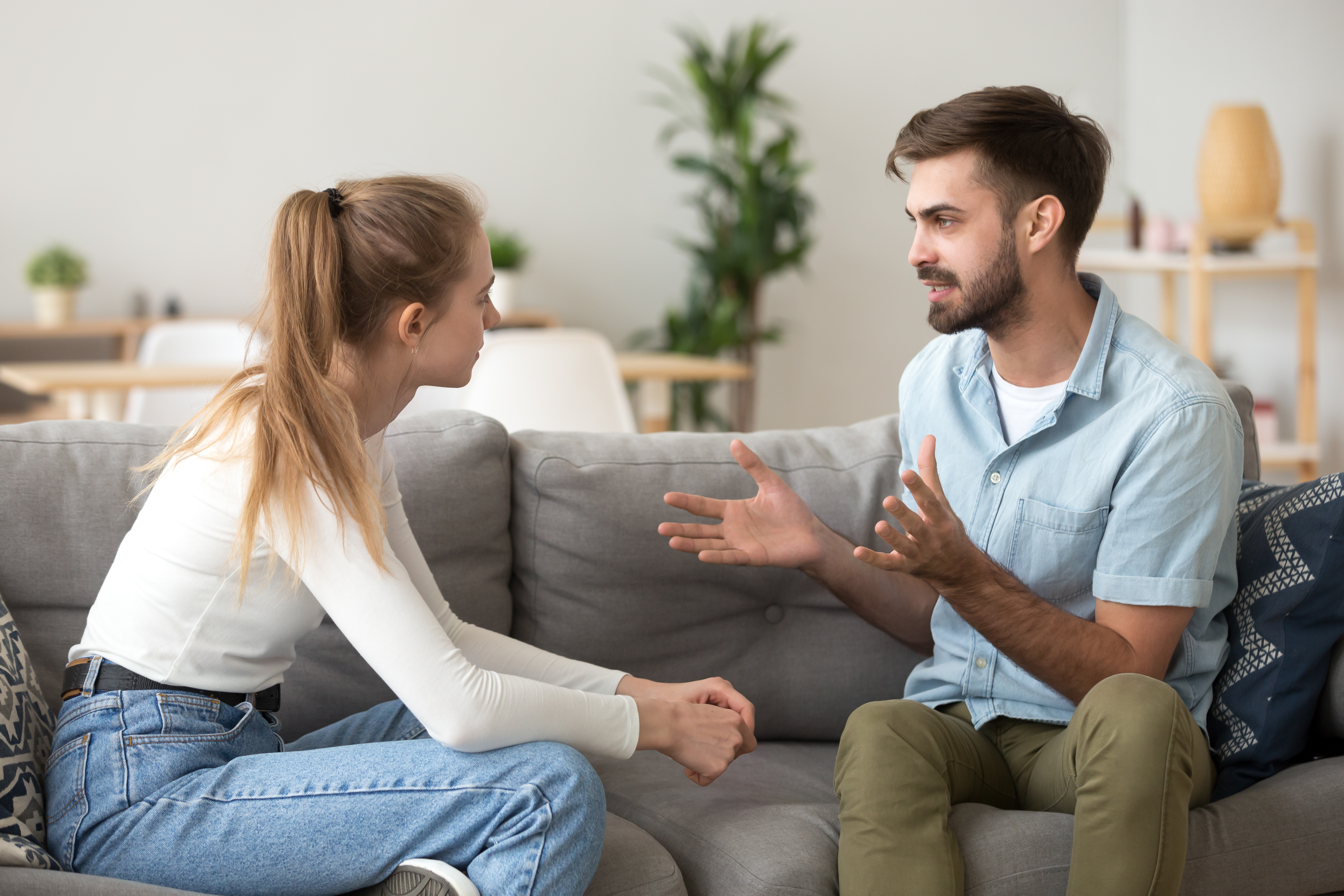 A couple talking on a sofa | Source: Shutterstock