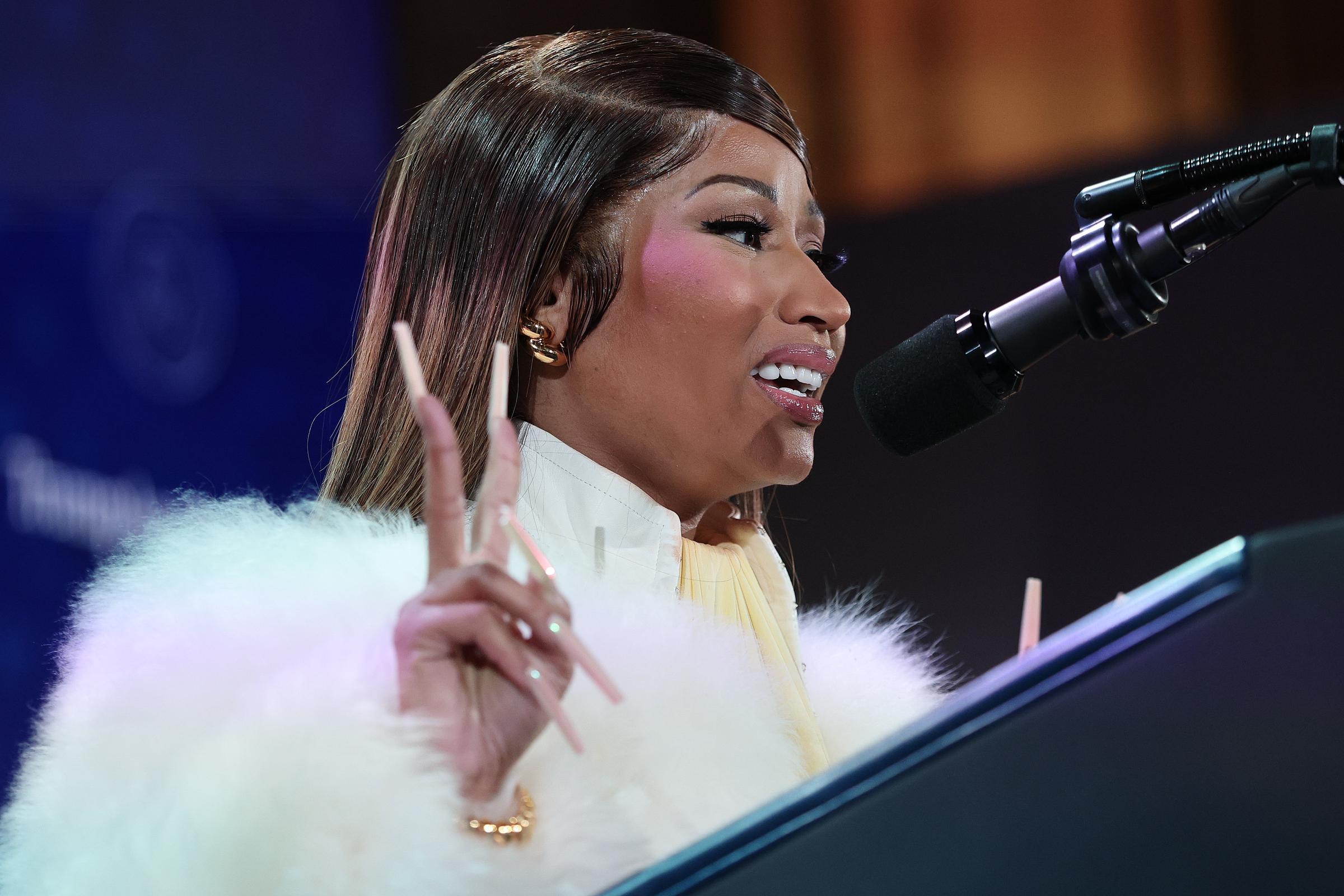 Nicki Minaj speaking onstage during the summit at the Andrew W. Mellon Auditorium. | Source: Getty Images