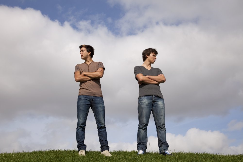 Two men arguing in a field. | Source: Shutterstock