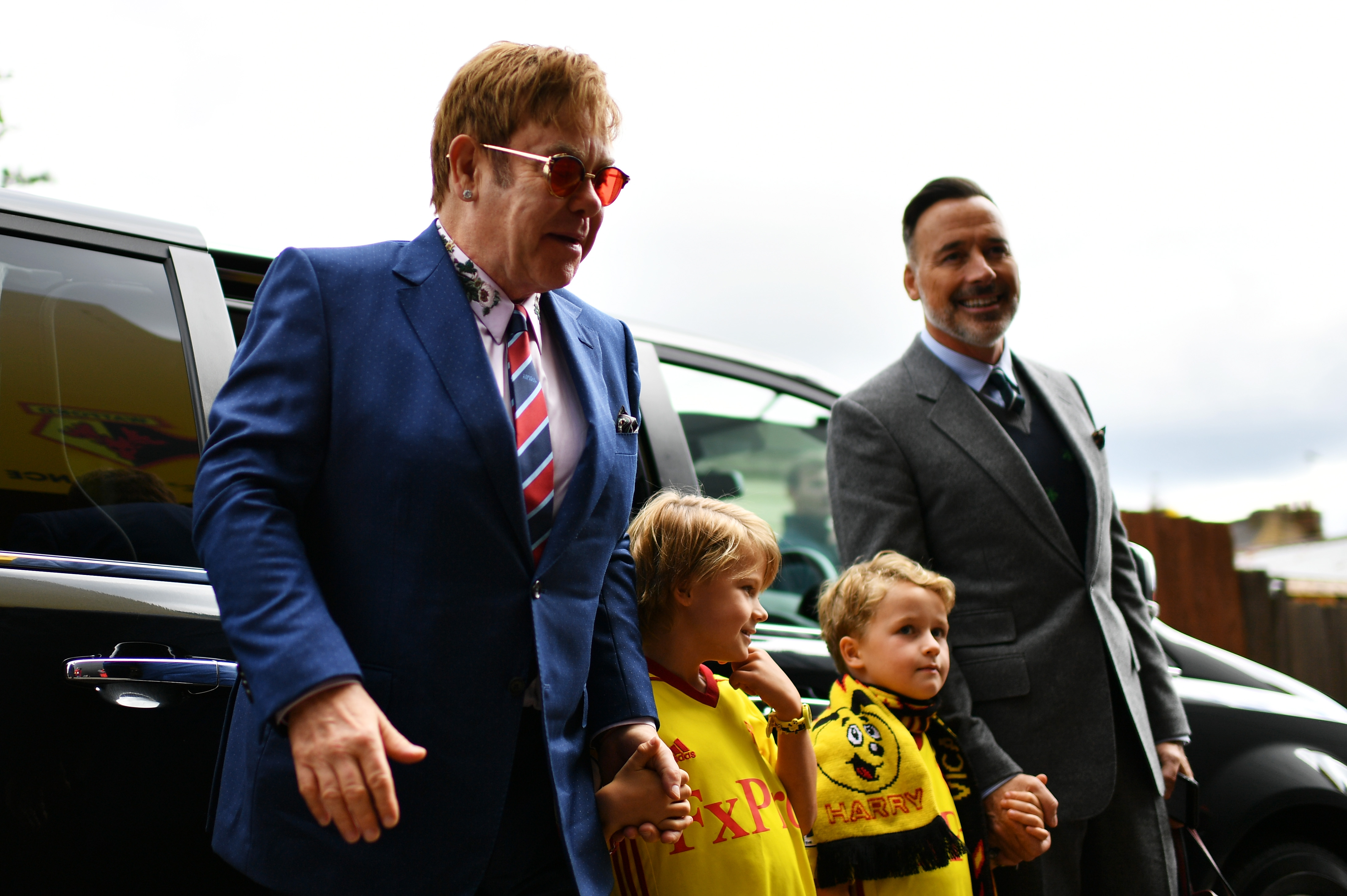 Elton John and David Furnish with their sons Zachary Jackson and Elijah Joseph Daniel Furnish-John arriving for the Premier League match between Watford and Manchester City in Watford, England on September 16, 2017. | Source: Getty Images