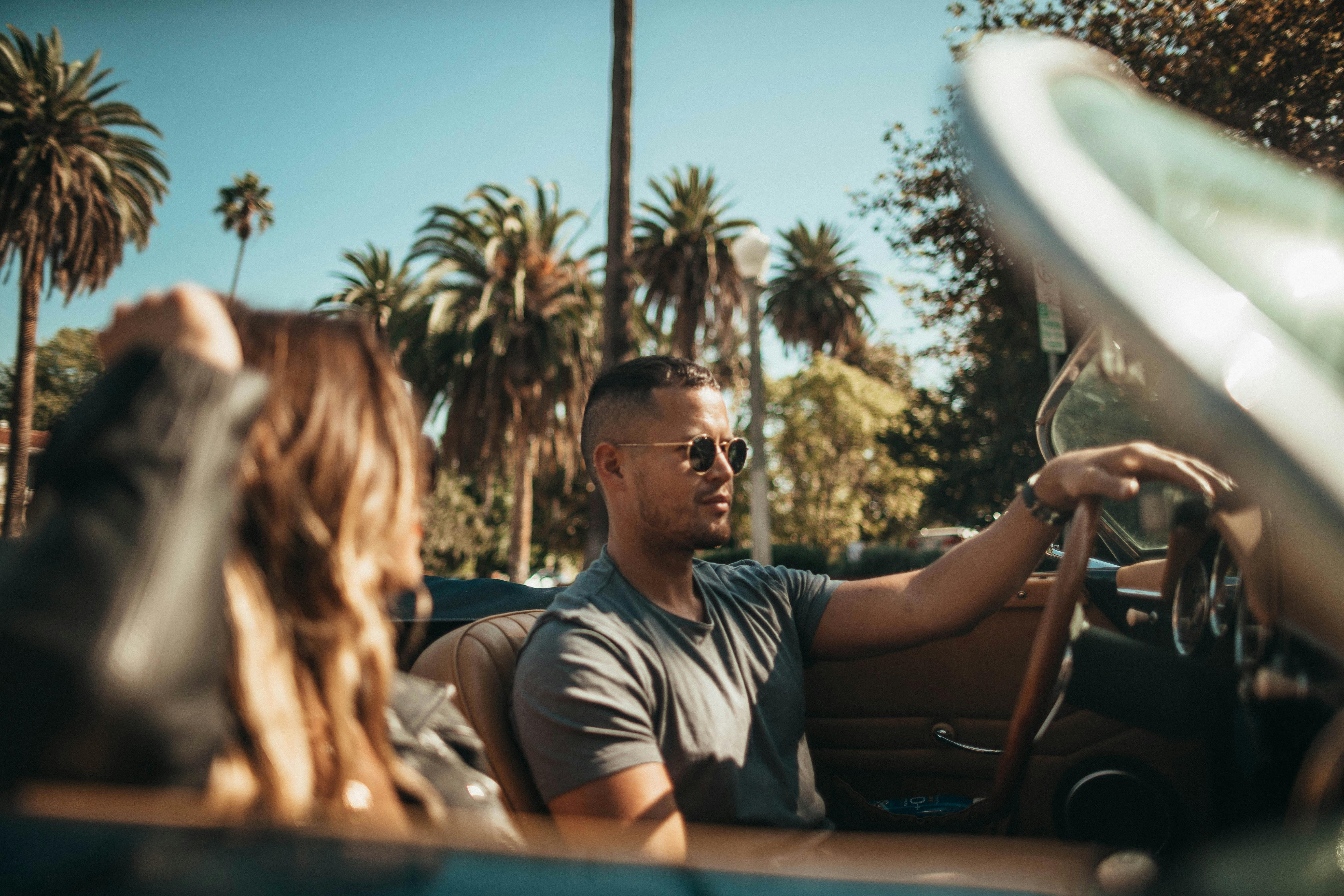 A couple driving in a convertible car | Source: Pexels