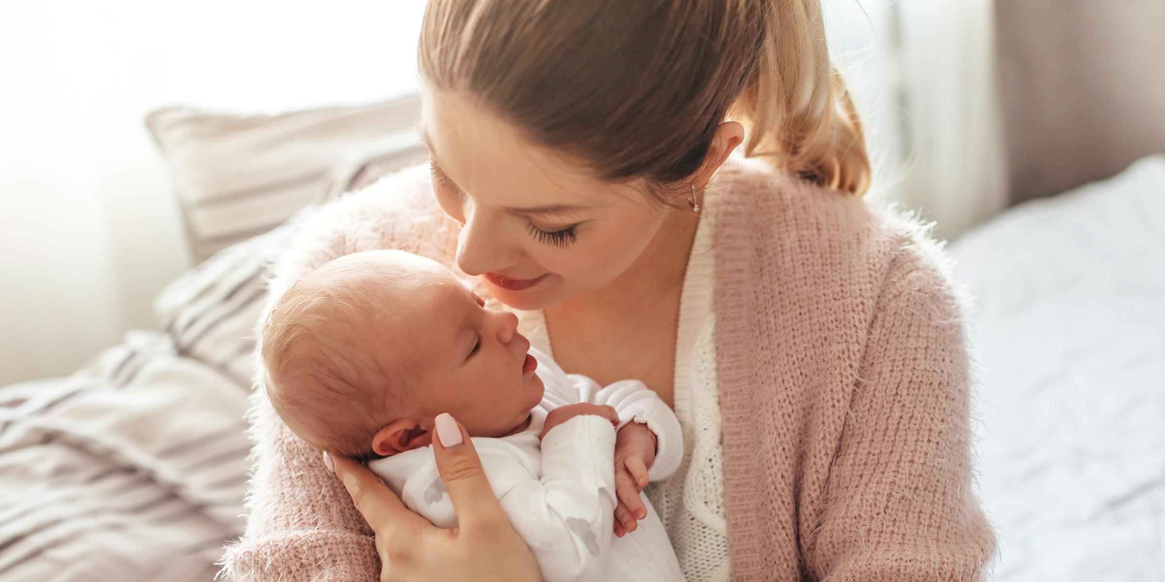 A woman holding her newborn baby | Source: Shutterstock