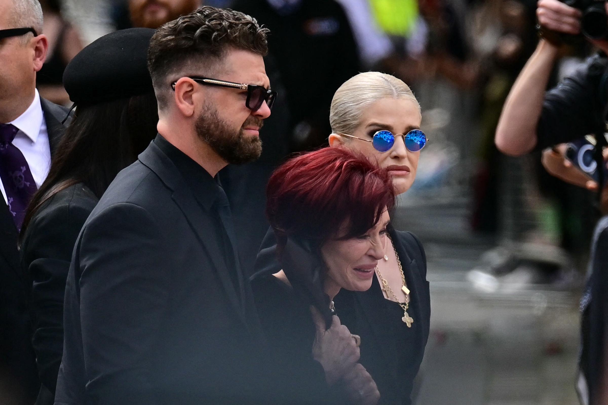 Sharon, Jack and Kelly Osbourne arrive to lay flowers at the Black Sabbath Bridge during a funeral procession for Ozzy in Birmingham on July 30, 2025 | Source: Getty Images