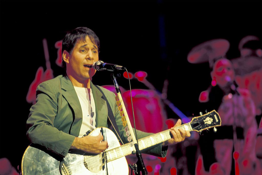 Paul Simon plays guitar during the tour in support of his 'Graceland' album on stage at the Jones Beach Theatre, Wantagh, New York, July 6, 1987. | Photo: Getty Images