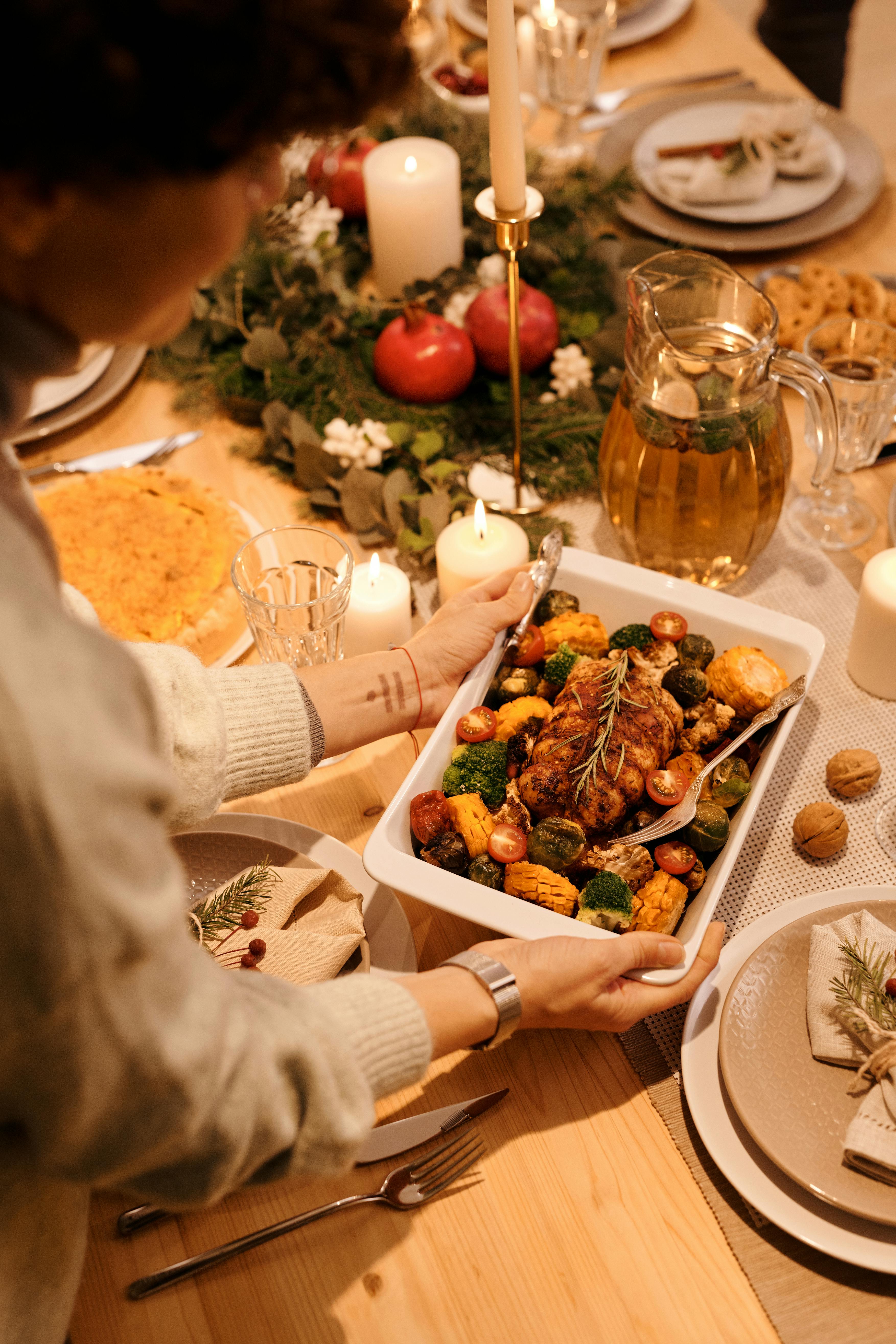 A woman placing a tray of food on the table | Source: Pexels