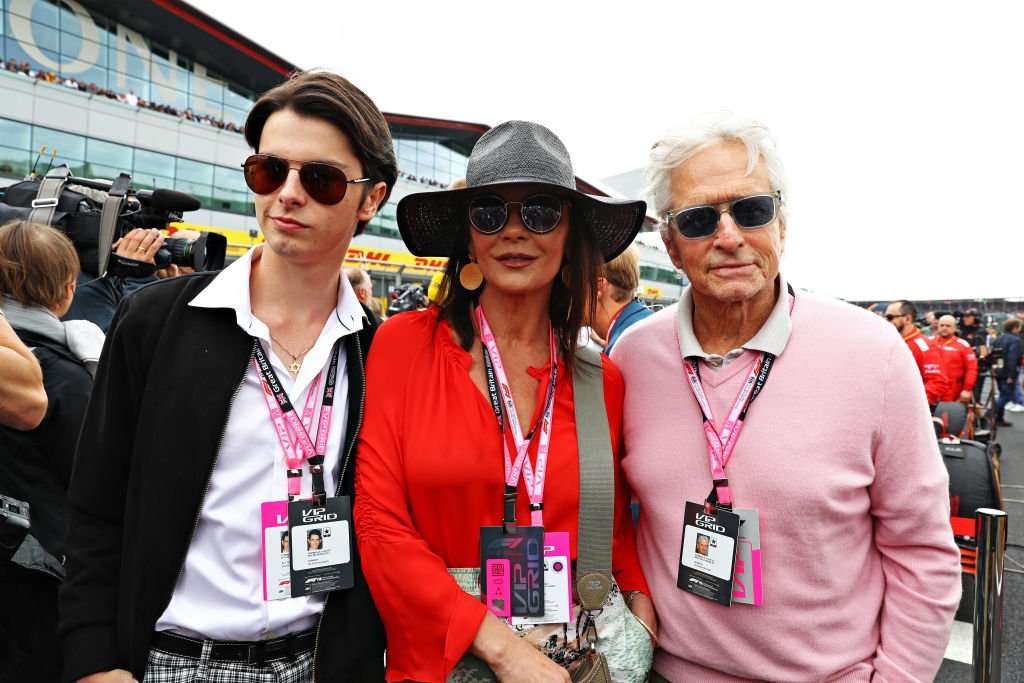 Actors Michael Douglas and Catherine Zeta-Jones and their son Dylan Douglas pose for a photo on the grid before the F1 Grand Prix of Great Britain at Silverstone | Photo: Getty Images