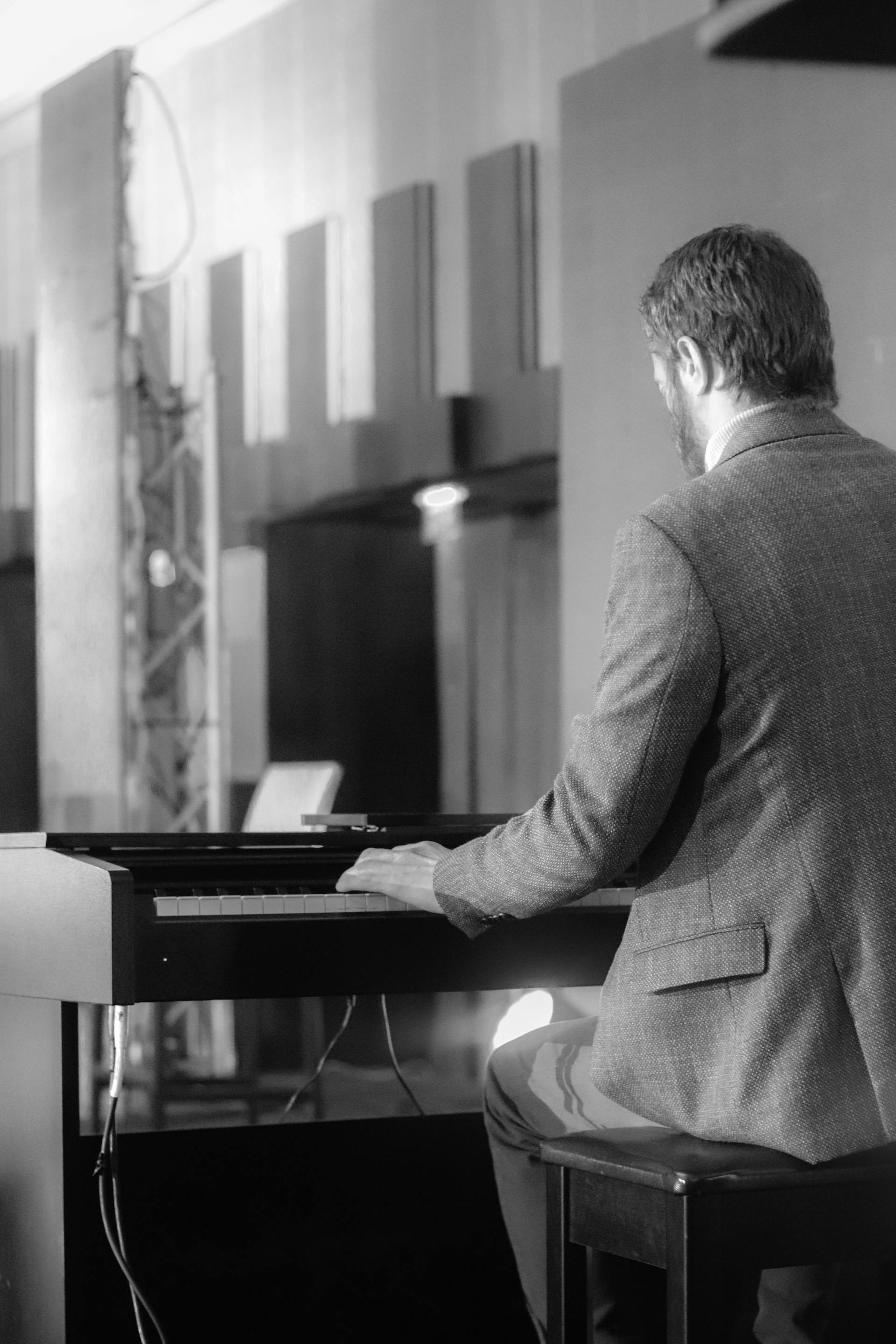 A grayscale photo of a man playing a piano | Source: Pexels