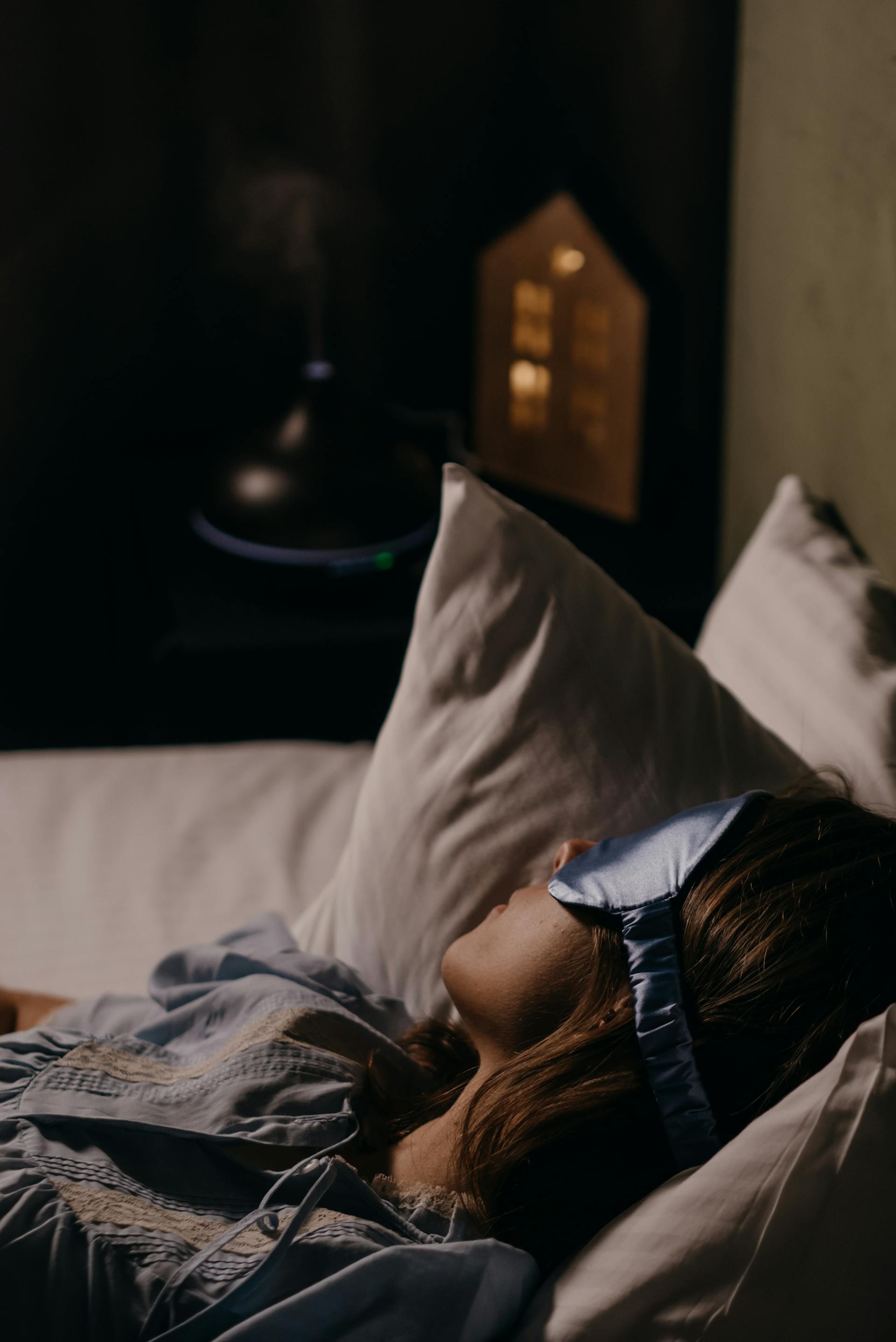 A woman sleeping while wearing an eye mask | Source: Pexels
