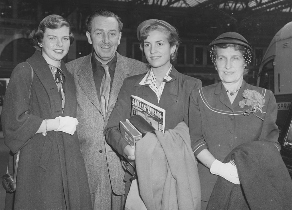  Walt Disney, creator of Mickey Mouse, with his wife and two daughters at Waterloo station after arriving on the Queen Mary boat train | Getty Images