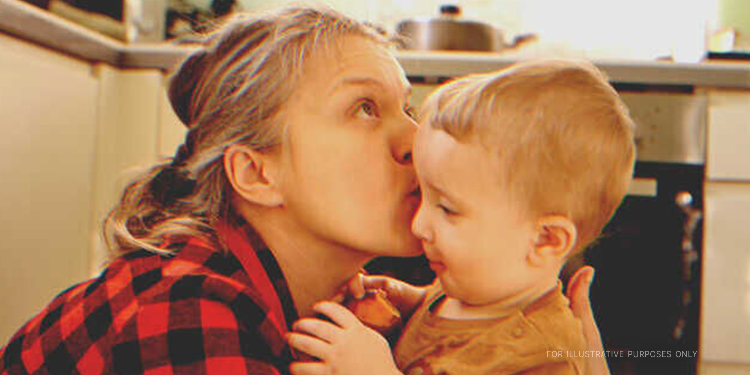 Mother kissing her little son | Shutterstock 