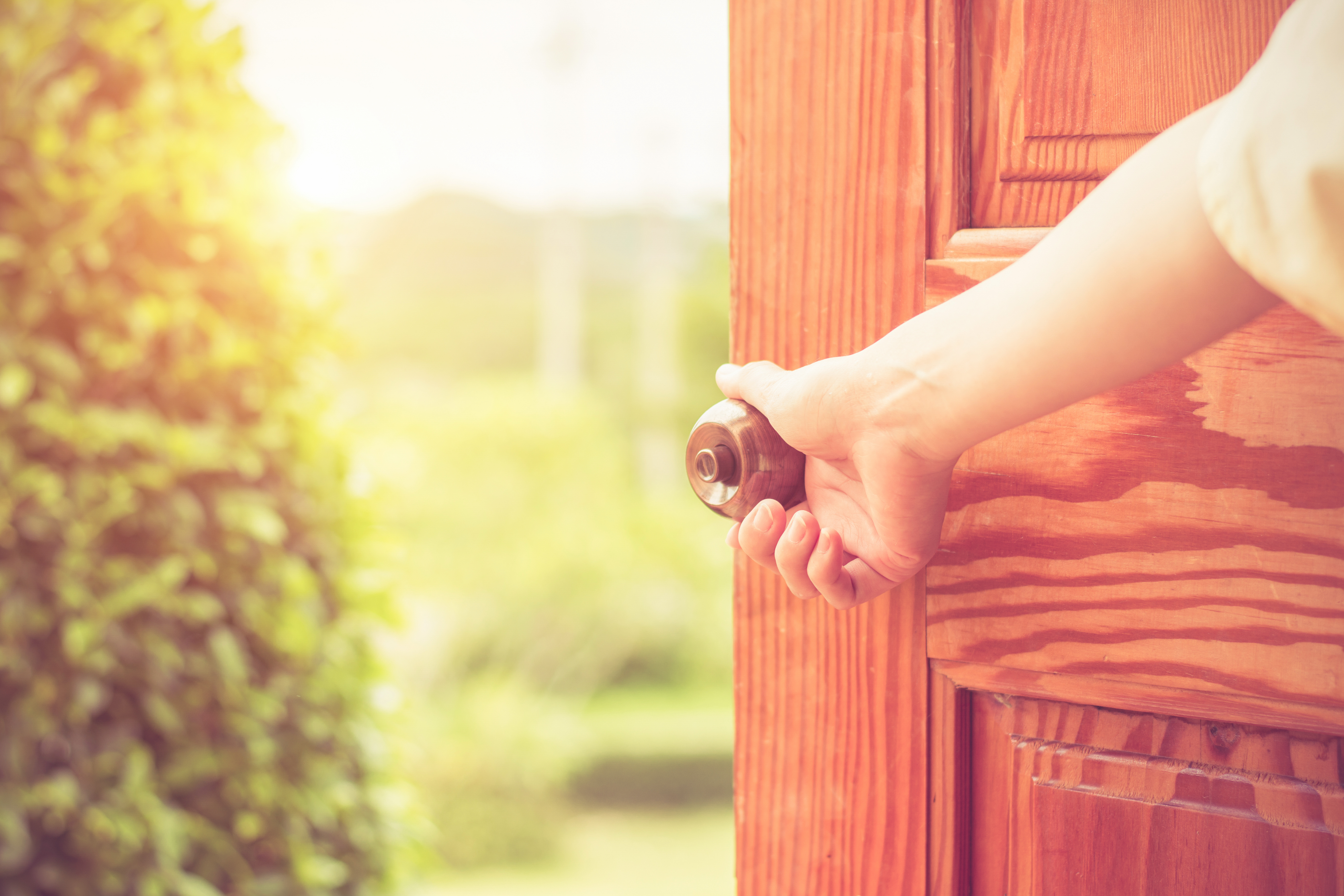 Women hand open door knob | Source: Shutterstock