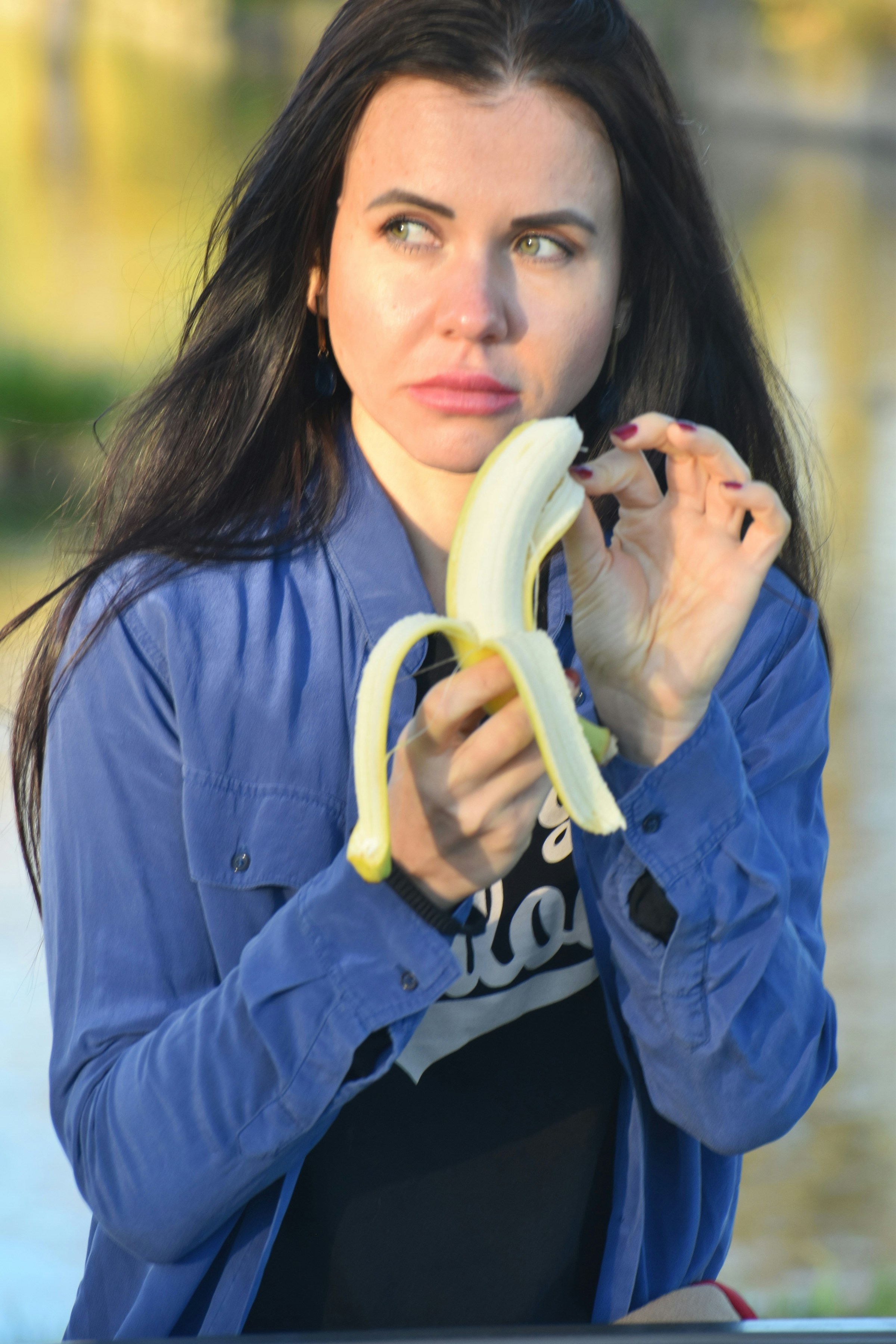 A woman eating a banana | Source: Unsplash