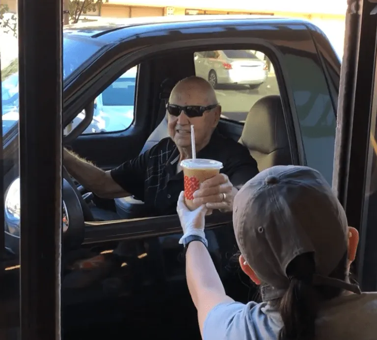 Gilbert "Gil" Walker ordering at Dunkin' Donuts. | Photo: Facebook/localishinspire