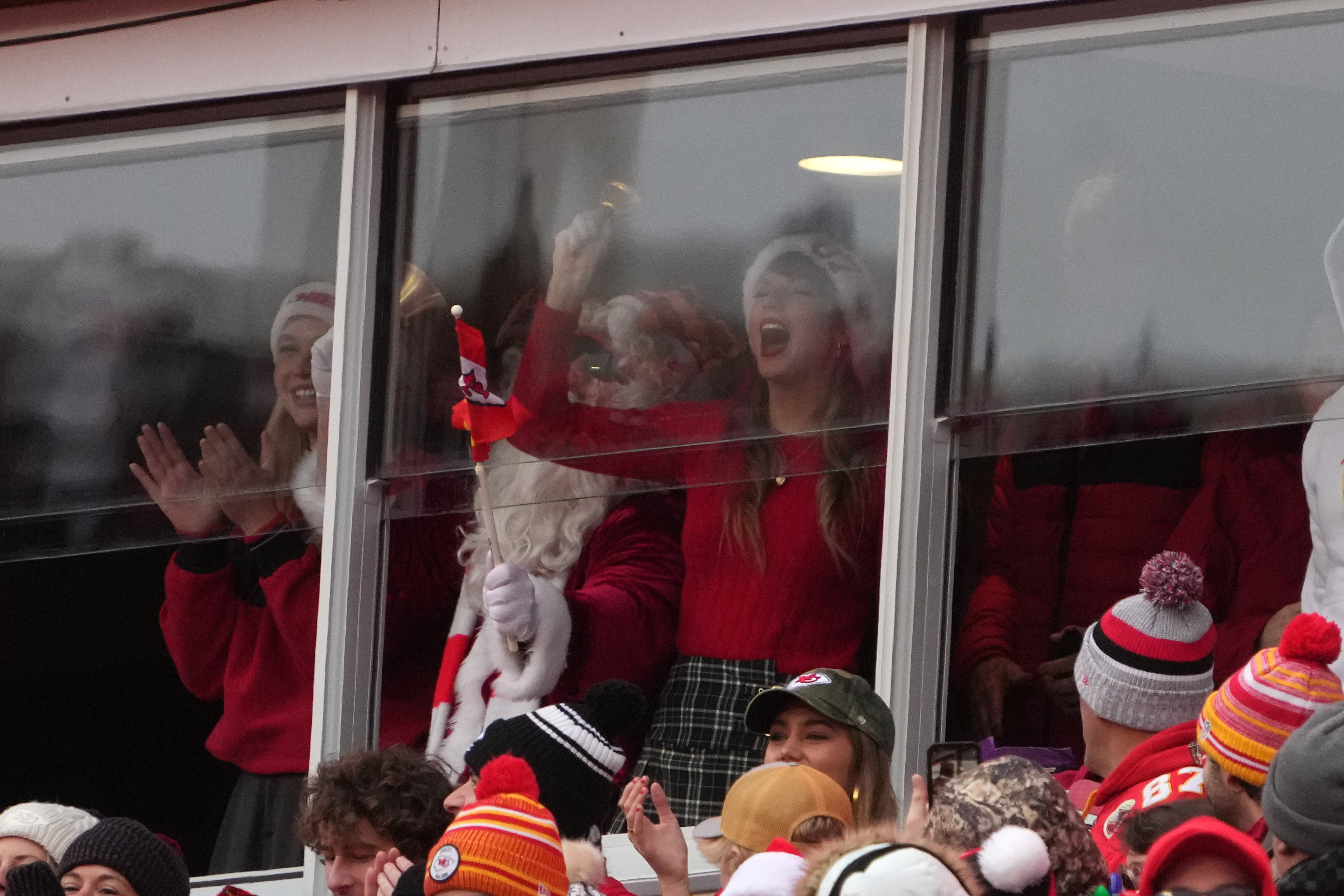 Taylor Swift in a suite ringing a bell during the first half of an NFL football game between the Kansas City Chiefs and the Las Vegas Raiders on December 25, 2023, in Kansas City, Missouri | Source: Getty Images