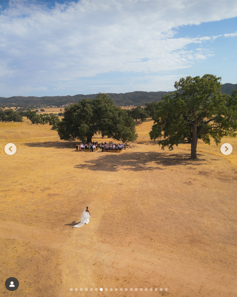 A bird's-eye view of Britt Stewart walking down the aisle at Riata Ranch on her wedding day, posted on August 27, 2025. | Source: Instagram/samkoma.world and maksmaakphoto
