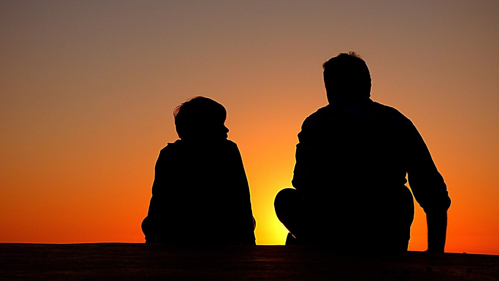 The silhouette of a father and son. | Source: Pixabay. 