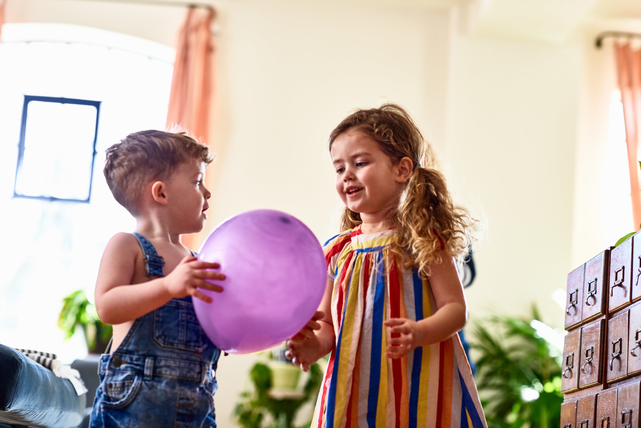 An image showing two Girls playing with a balloon | Photo: Getty Images