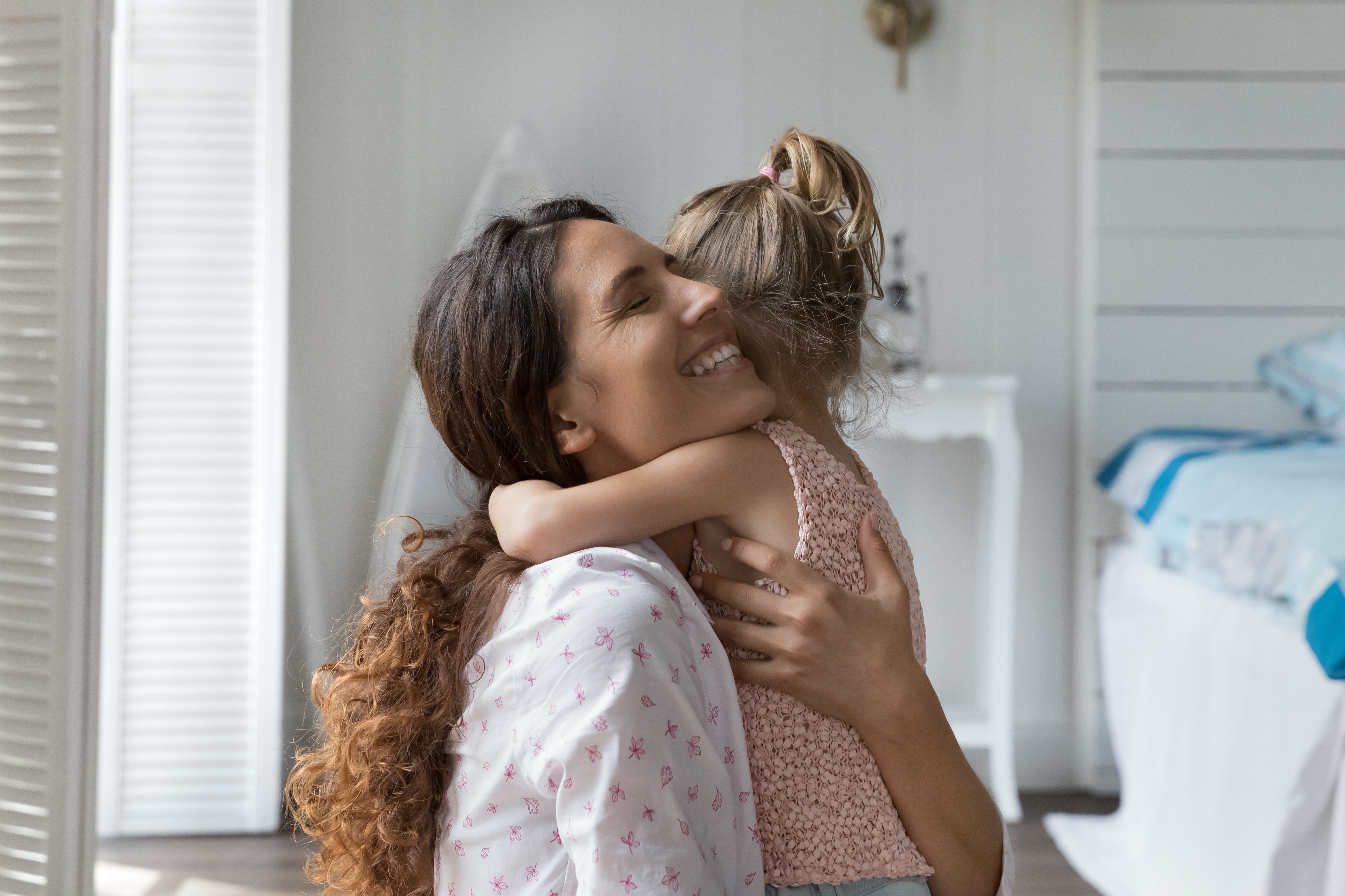A mother hugging her daughter | Source: Shutterstock