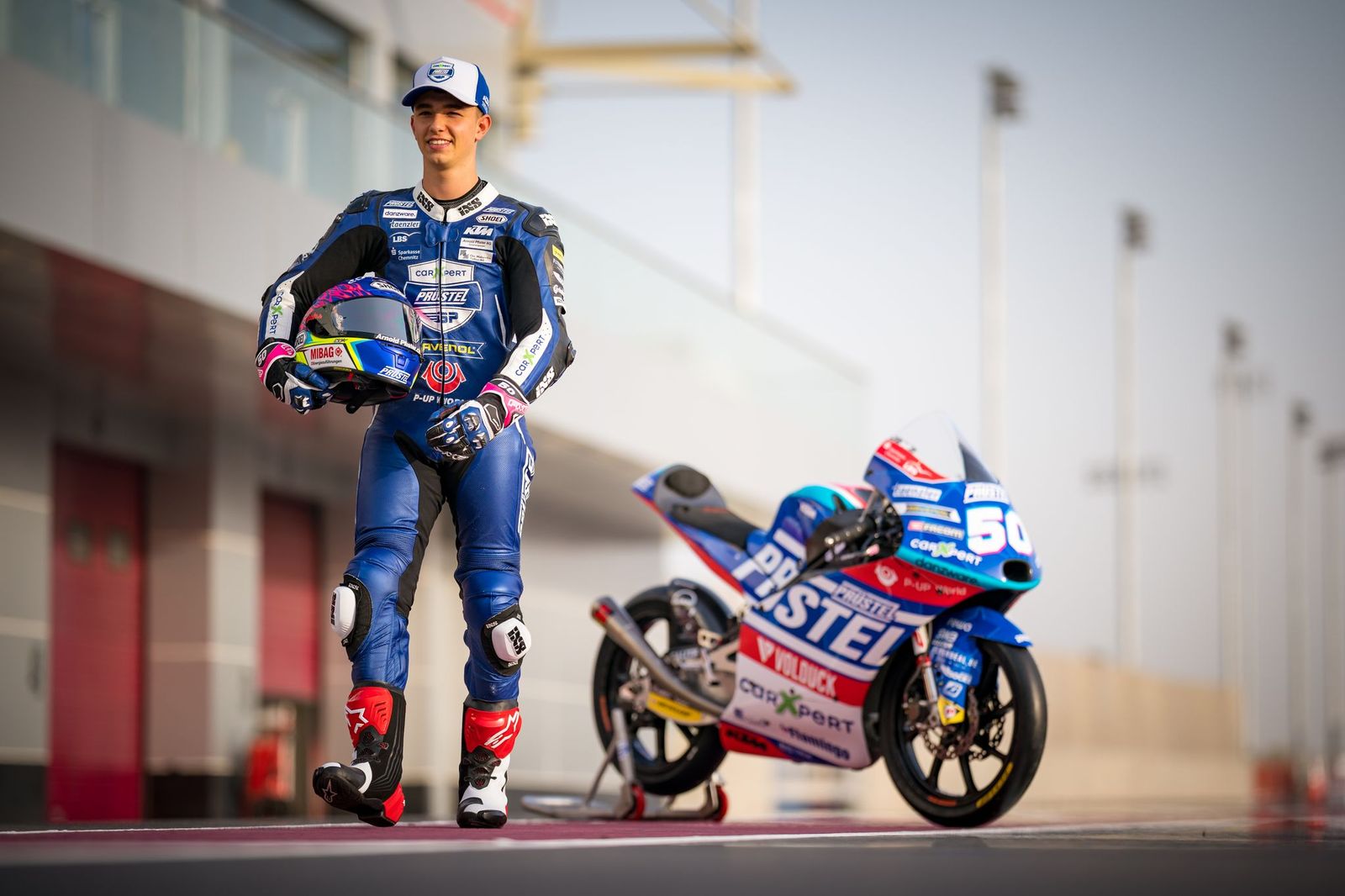 Jason Dupasquier walks in front of his bike during a PruestelGP photo shooting at Losail Circuit on April 1, 2021, in Doha, Qatar | Photo: Steve Wobser/Getty Images
