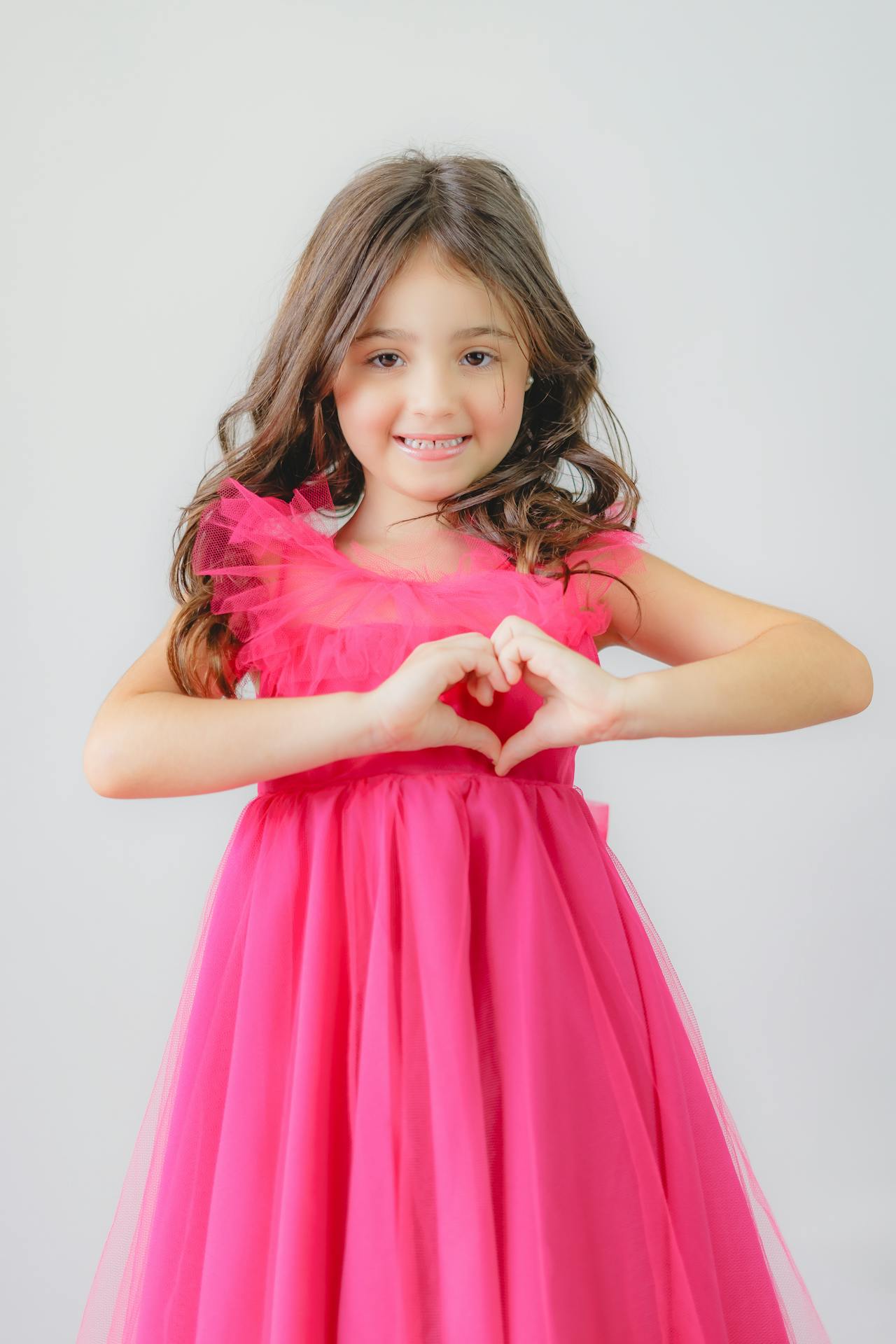 A young girl in a pink dress | Source: Pexels