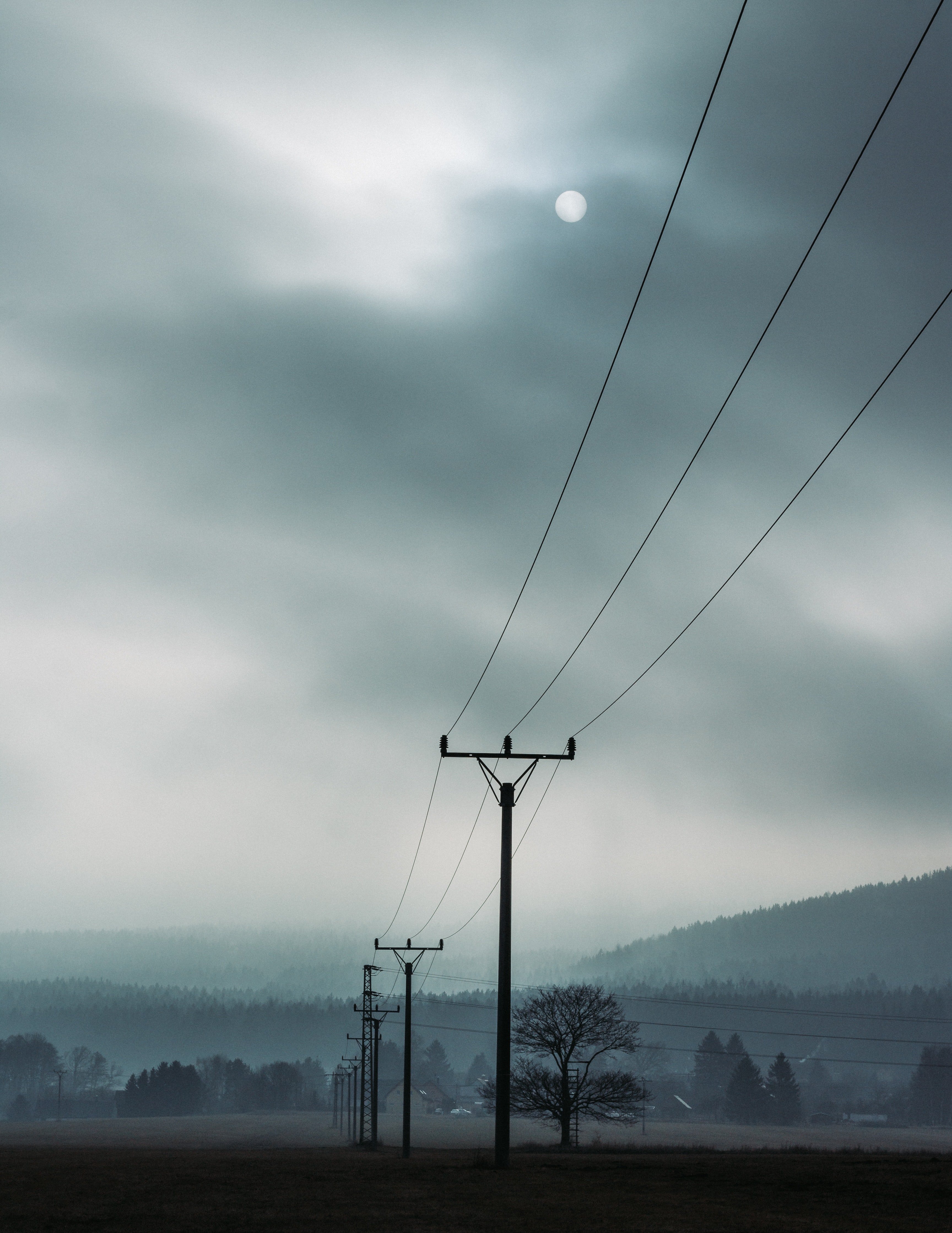 Landscape picture of electric posts on a cloudy day. | Source: Pexels.