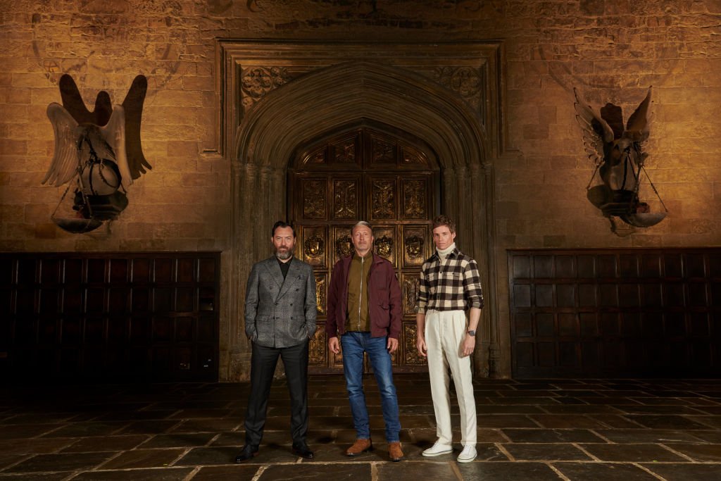 Jude Law, Mads Mikkelsen, and Eddie Redmayne attend a photocall for "Fantastic Beasts: The Secrets of Dumbledore" in the Great Hall at Warner Bros. Studio Tour London on March 29, 2022 in England. | Source: Getty Images