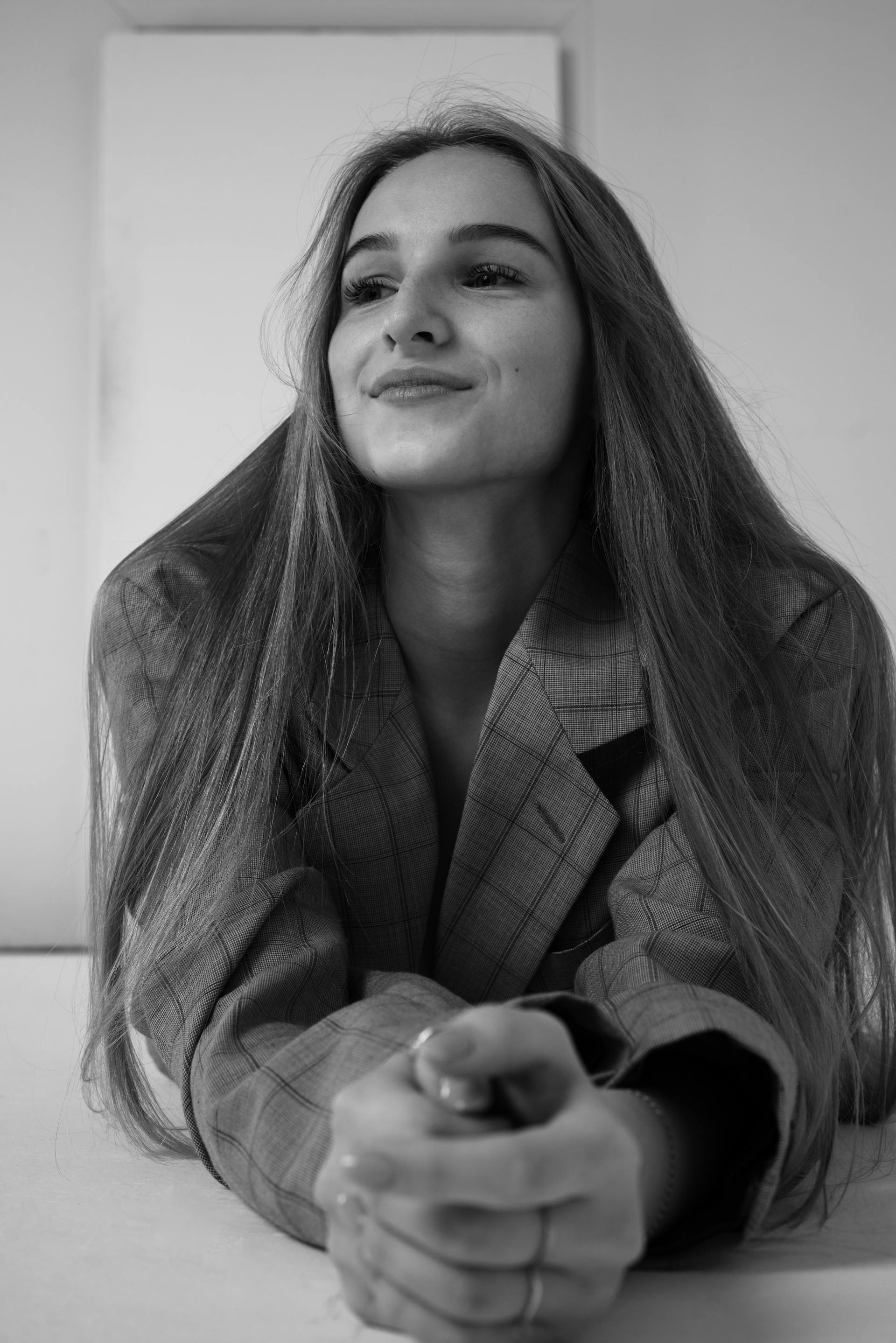 Grayscale photo of a young woman smiling | Source: Pexels