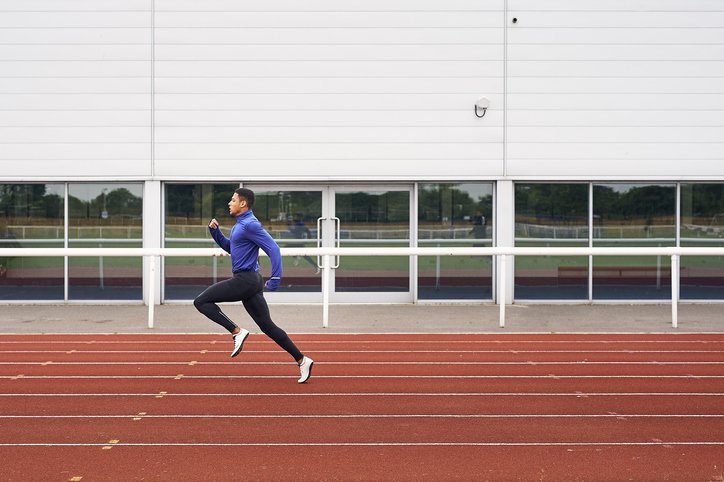 A male runner training on running track | Photo: Getty Images