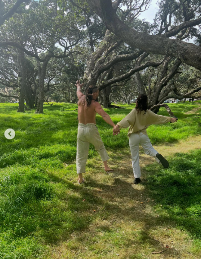 Jason Momoa holds hands with Adria Arjona, from a post dated August 1, 2025. | Source: Instagram/adriaarjona