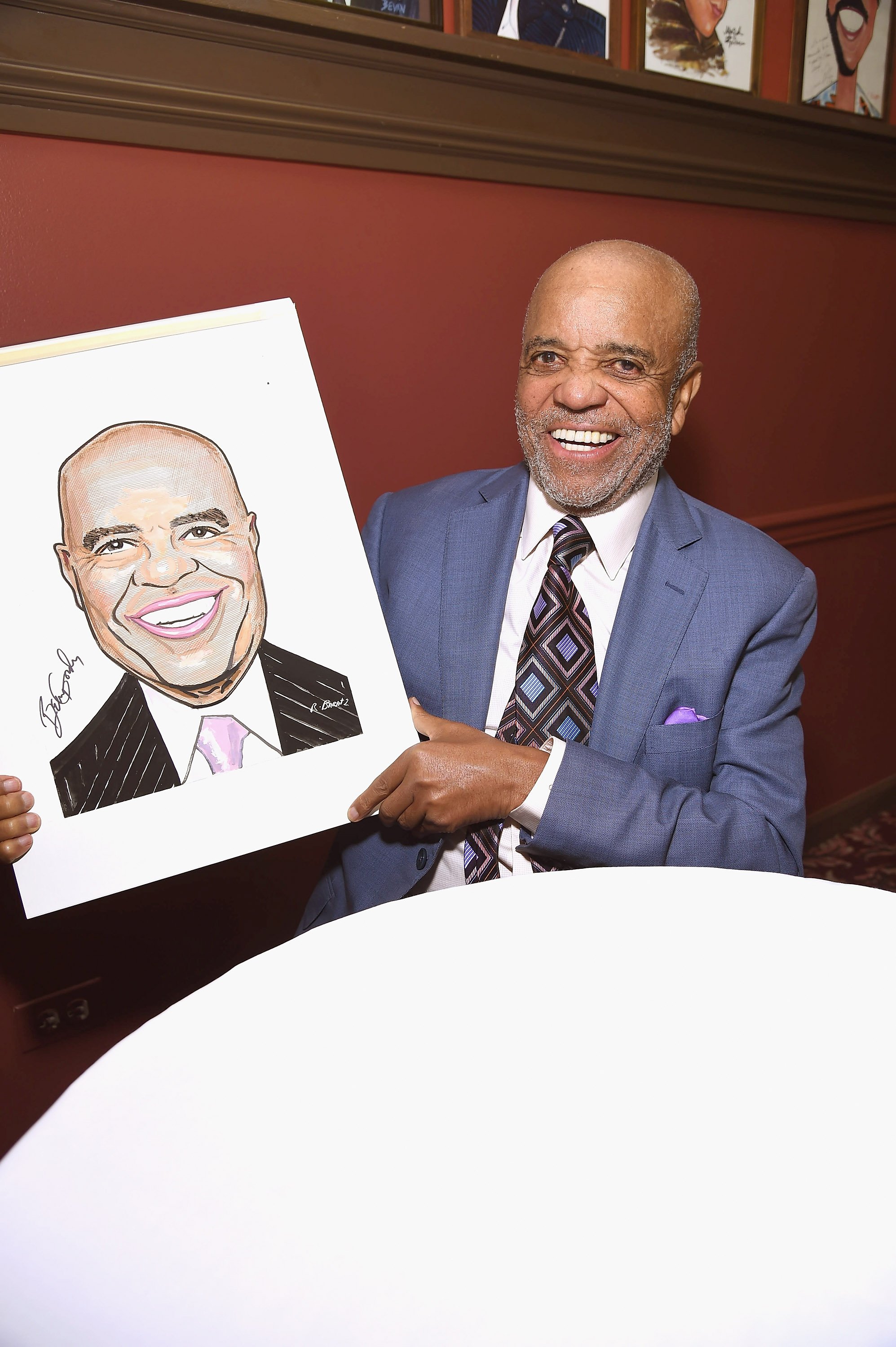 Berry Gordy smiles with his portrait in New York City in July 2016. | Photo: Getty Images