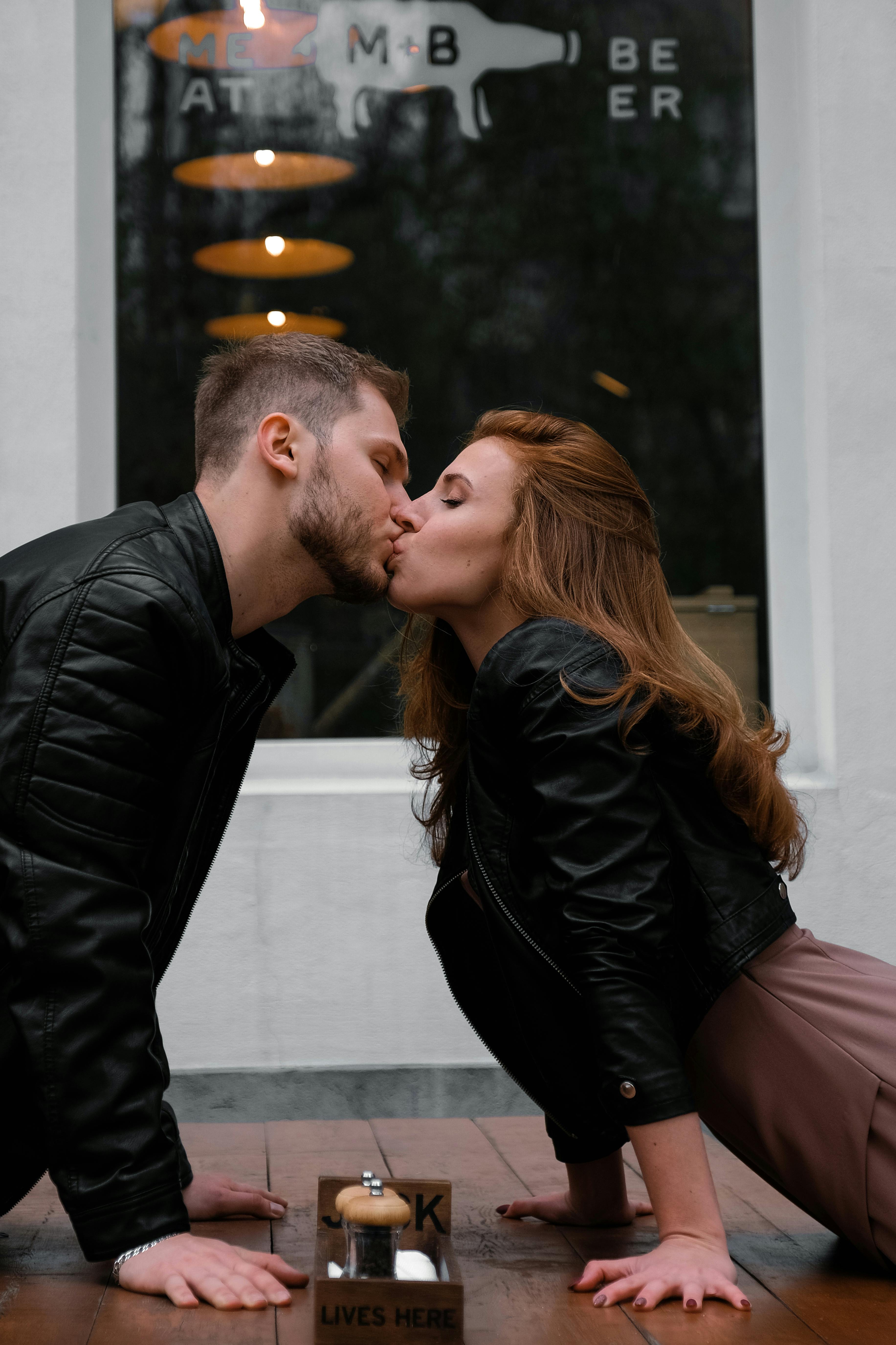 Man and woman kisses near the table | Source: Pexels