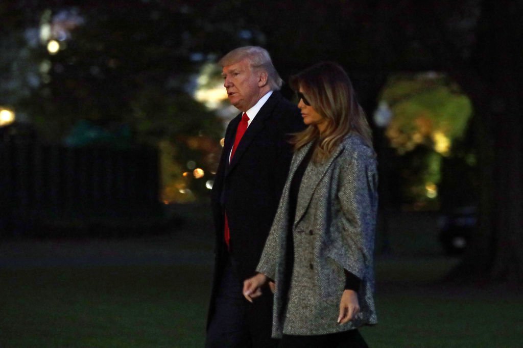 President Donald Trump and first lady Melania Trump walk on the South Lawn after they returned to the White House | Photo: Getty Images