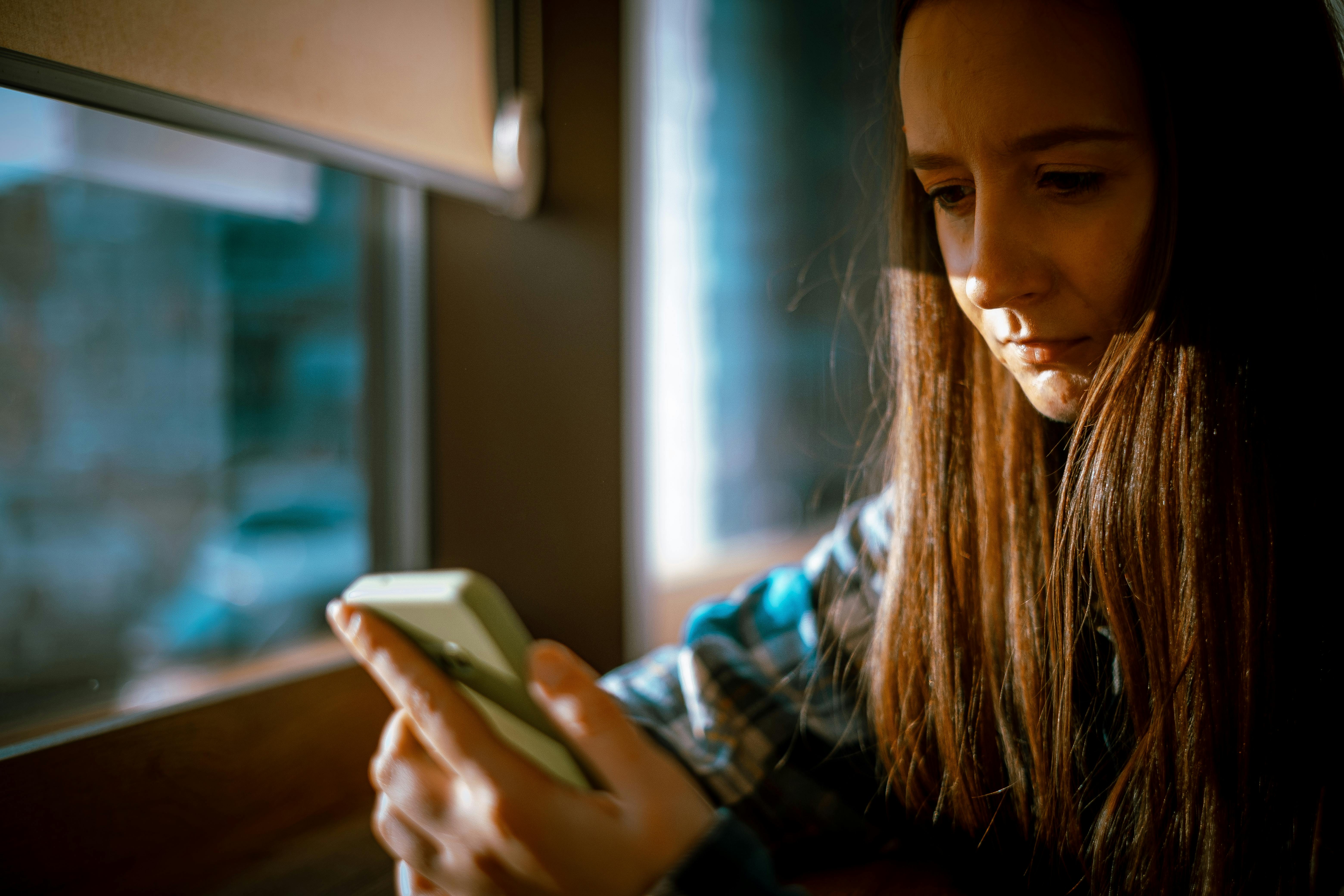 A woman looking at her phone | Source: Pexels