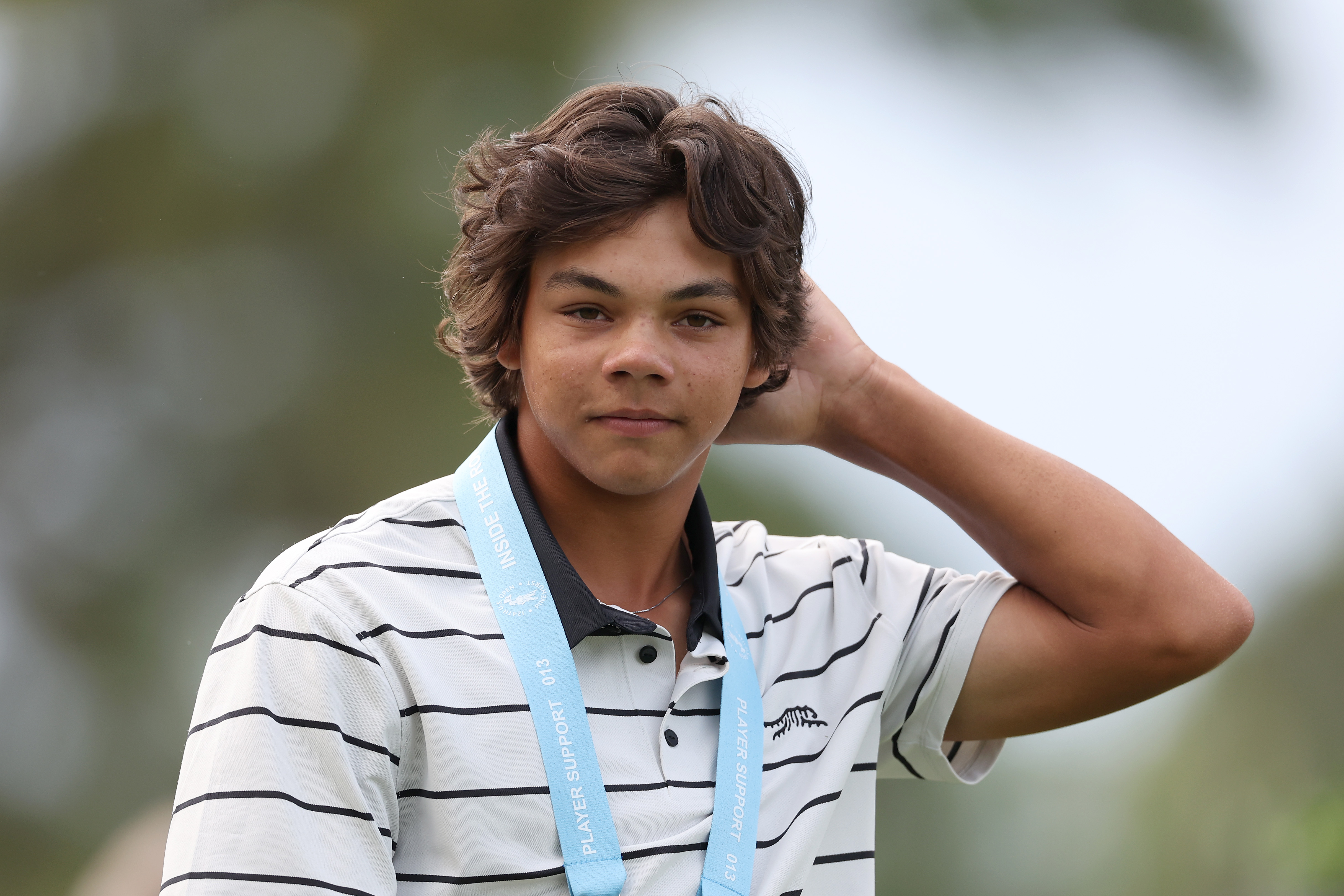 Charlie Axel Woods, son of Tiger Woods, pauses during a practice round at Pinehurst Resort. Calm and composed, he shows quiet confidence ahead of the U.S. Open.