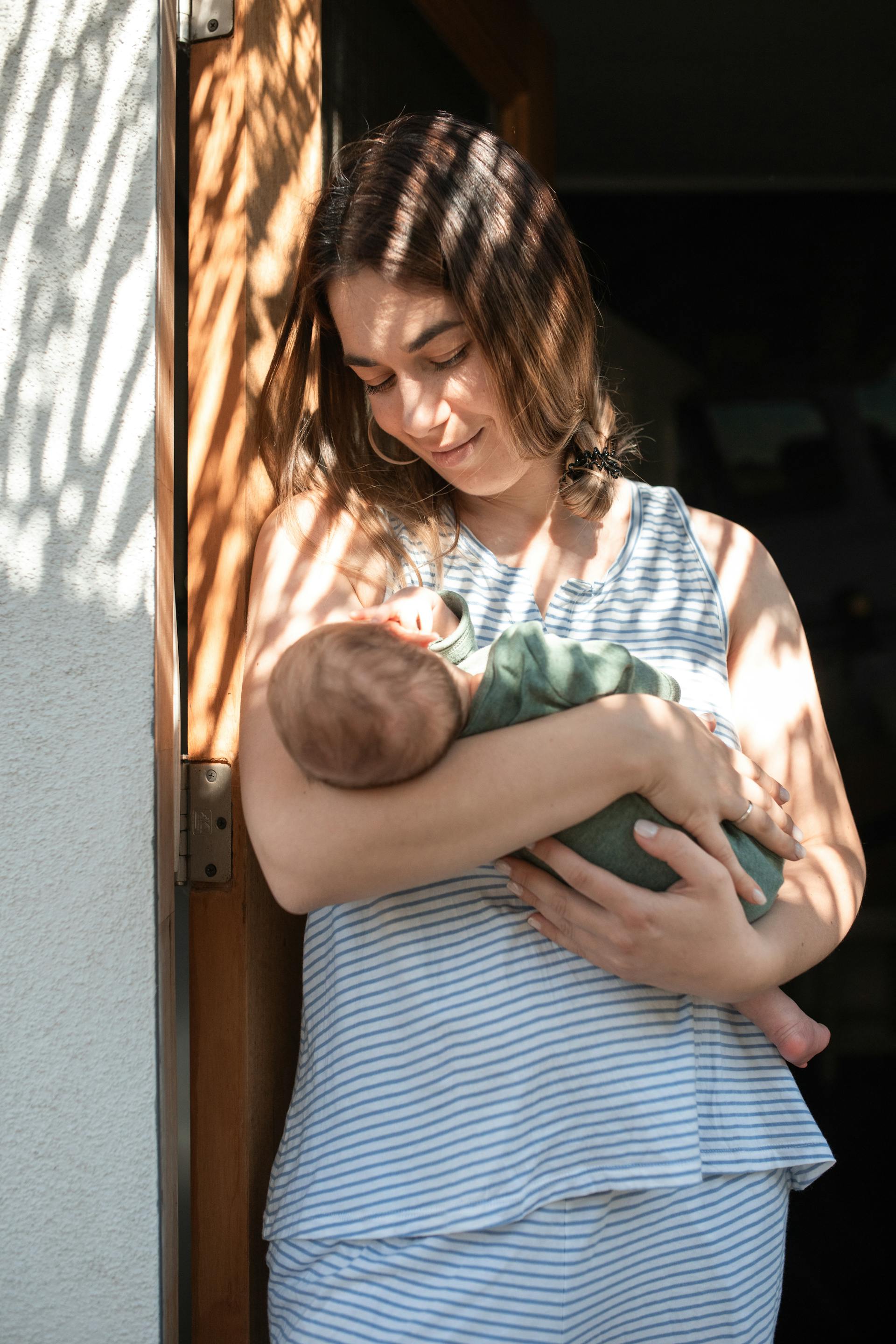 A woman holding her baby | Source: Pexels