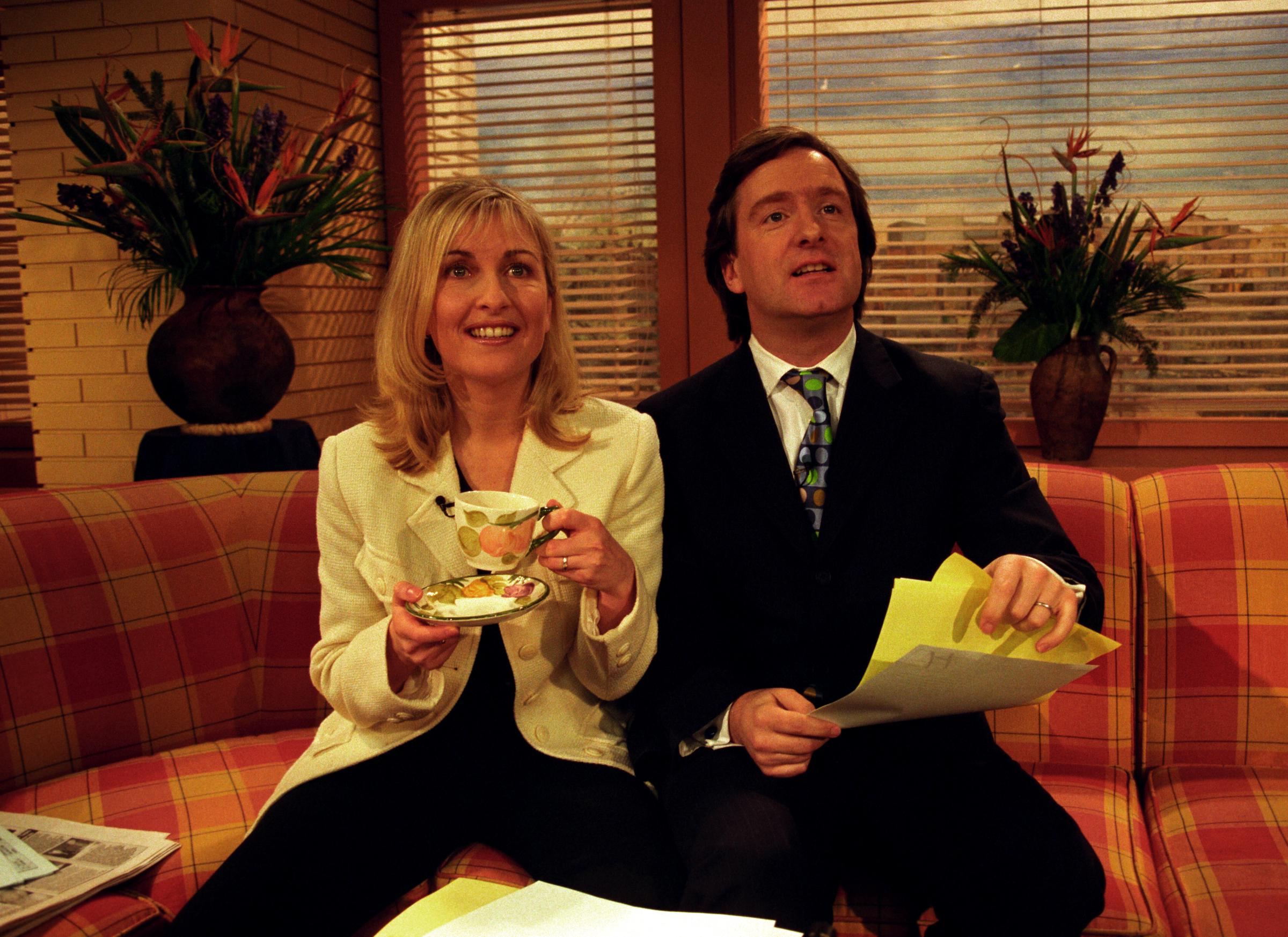 GMTV presenter Fiona Phillips is joined by a new co-host, her husband and GMTV reporter Martin Frizell, on 13 March 1998. | Source: Getty Images