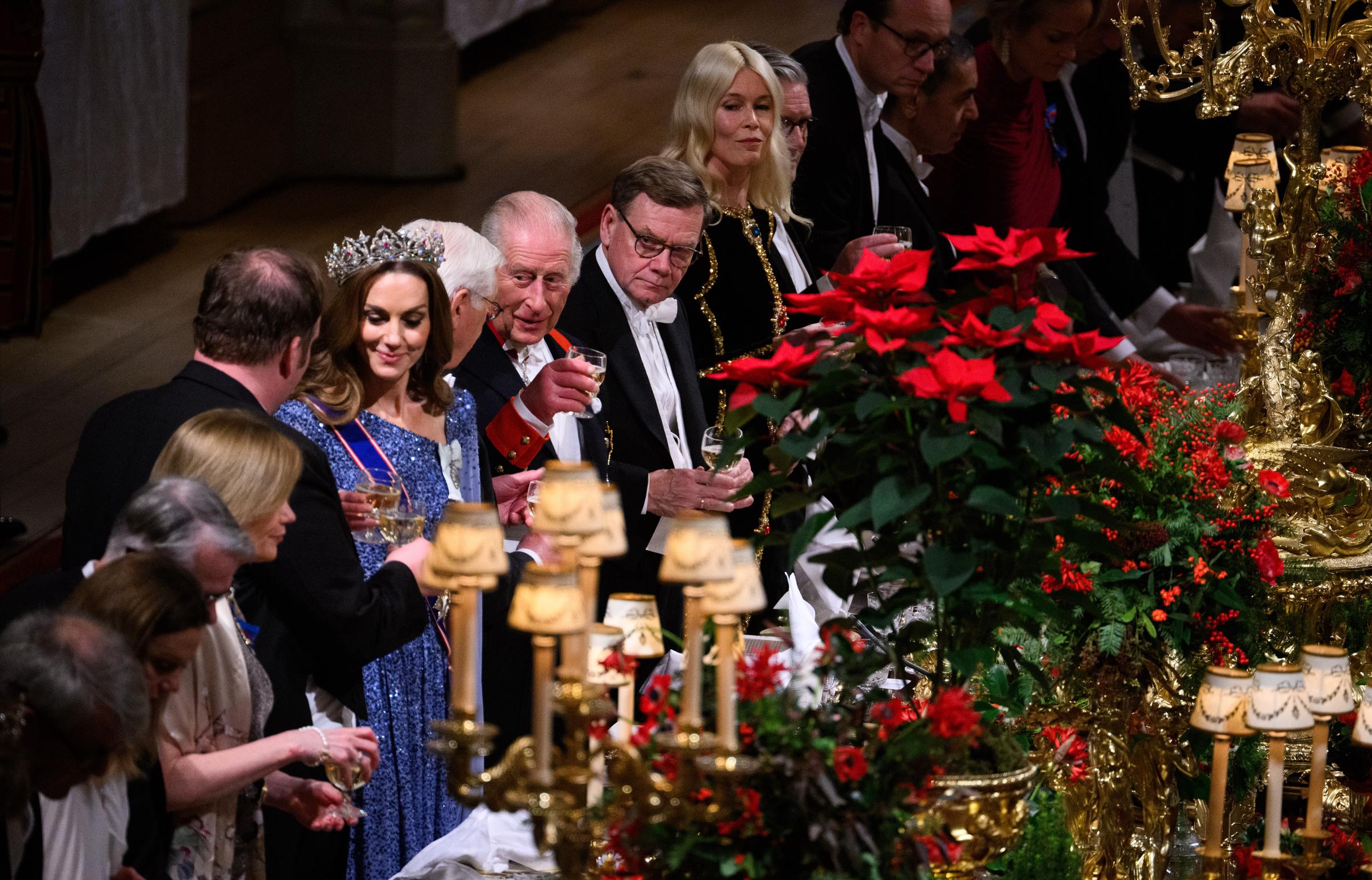 Amid glittering candelabras and festive red florals, Catherine, Princess of Wales, joined King Charles III, German President Frank-Walter Steinmeier, Claudia Schiffer, German Foreign Minister Johann Wadephul, and Prime Minister Sir Keir Starmer in raising a glass during the state banquet held in St. George's Hall at Windsor Castle.
