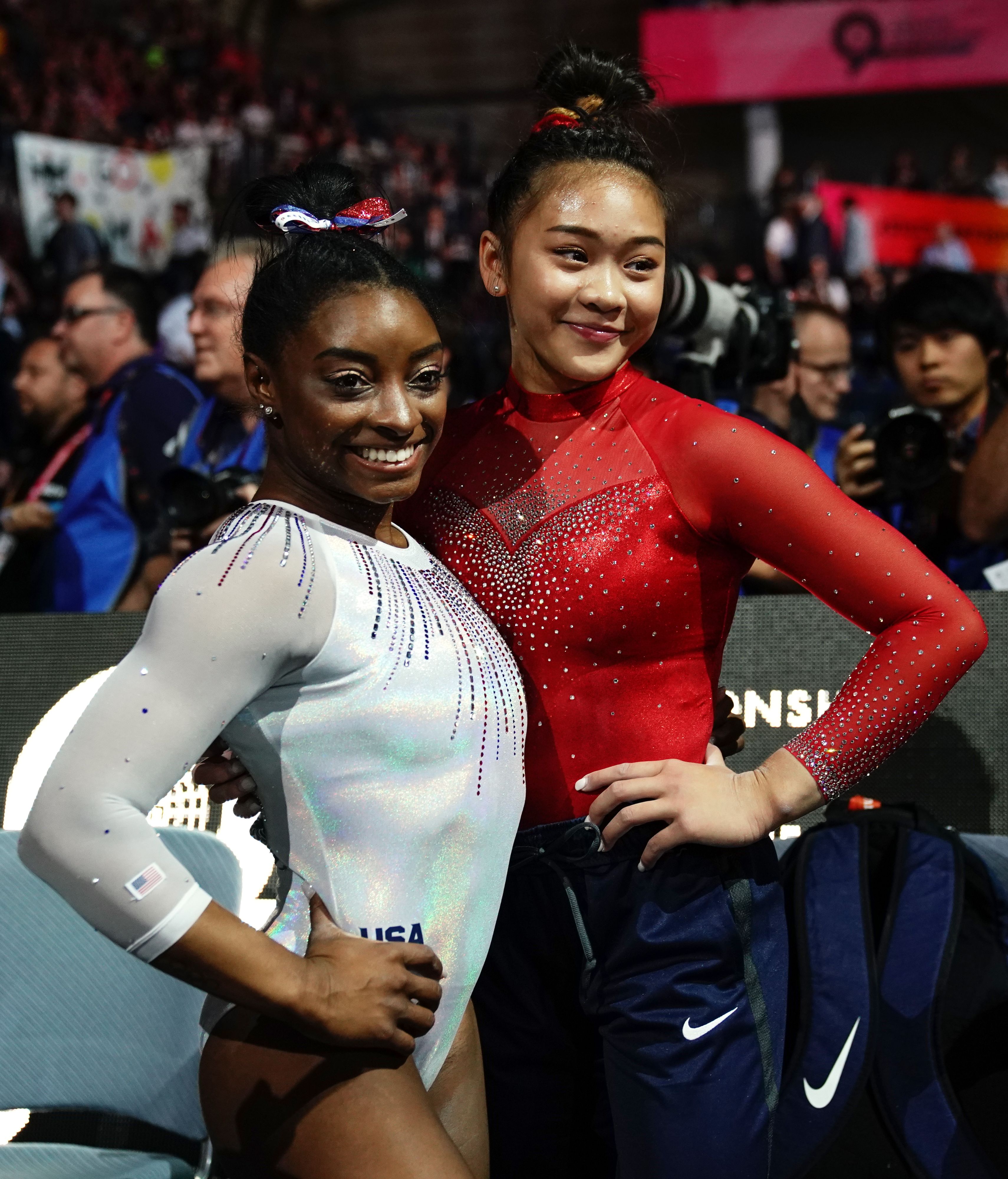 Simone Biles and her teammate Sunisa Lee after winning the gold medal in the womens all-around final at the FIG Artistic Gymnastics World Championships in Stuttgart, southern Germany, on October 10, 2019 | Source: Getty Images